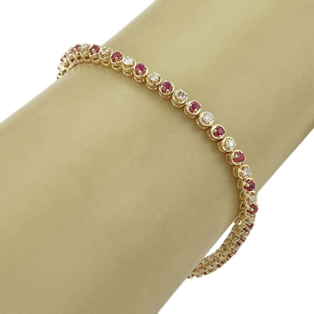 Vintage 14k Yellow Gold Tennis Bracelet with Diamonds and Rubies: Vintage 14k Yellow Gold Tennis Bracelet with Diamonds and Rubies This vintage tennis bracelet showcases a refined combination of natural diamonds and rubies set in 14k yellow gold. With a classic desi