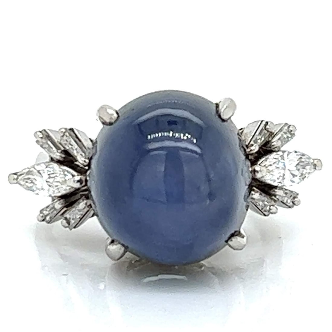 20.07 Ct Platinum Star Sapphire and 10 Diamond Ring: 20.07 Ct Platinum Star Sapphire and 10 Diamond Ring This exquisite Platinum Star Sapphire and Diamond Ring showcases a stunning 20.07 Ct. star sapphire, beautifully complemented by 10 diamonds totalin