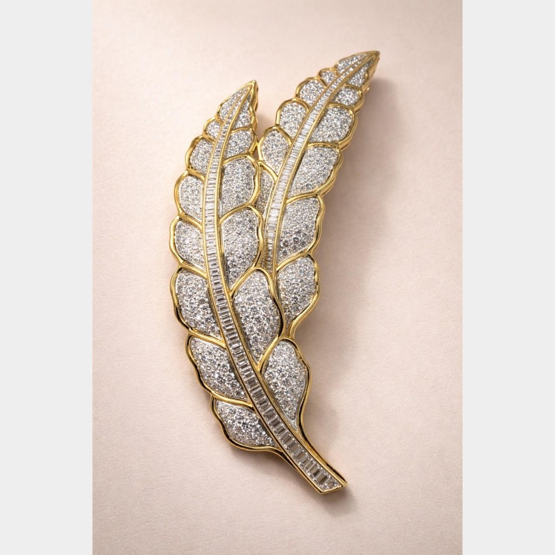 Diamond Leaf Brooch in 18K Gold and Platinum with Baguettes and Rounds: Diamond Leaf Brooch in 18K Gold and Platinum with Baguettes and Rounds This exquisite brooch by Tallarico is crafted from 18K yellow gold and platinum in an elegant leaf design. It is set with 351 rou