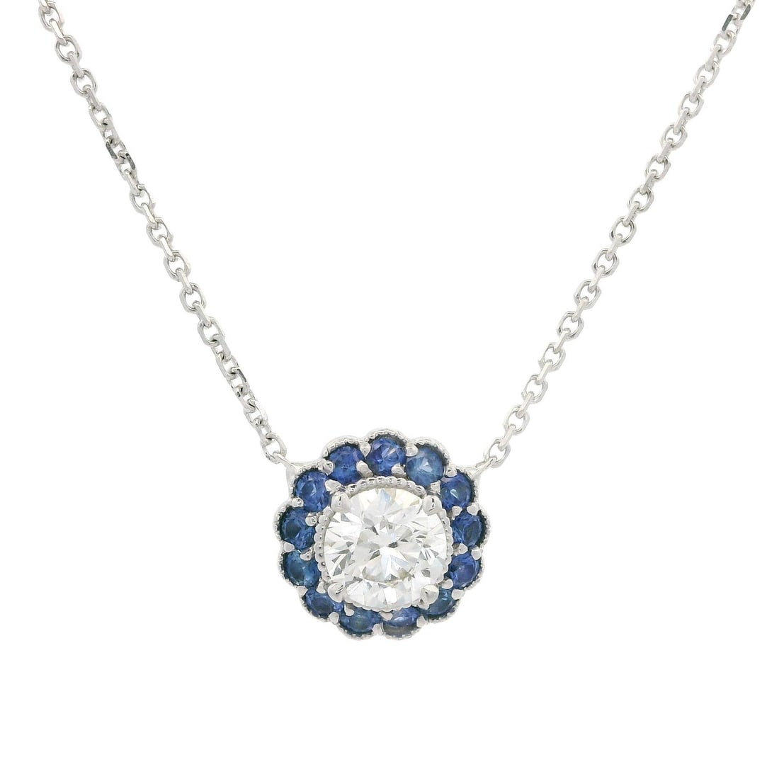 18k White Gold 0.91ct Diamond Sapphire Flower Halo Pendant Necklace: 18k White Gold 0.91ct Diamond Sapphire Flower Halo Pendant Necklace This exquisite pendant necklace features a stunning 0.91ct round diamond at its center, encircled by a captivating halo of royal blu