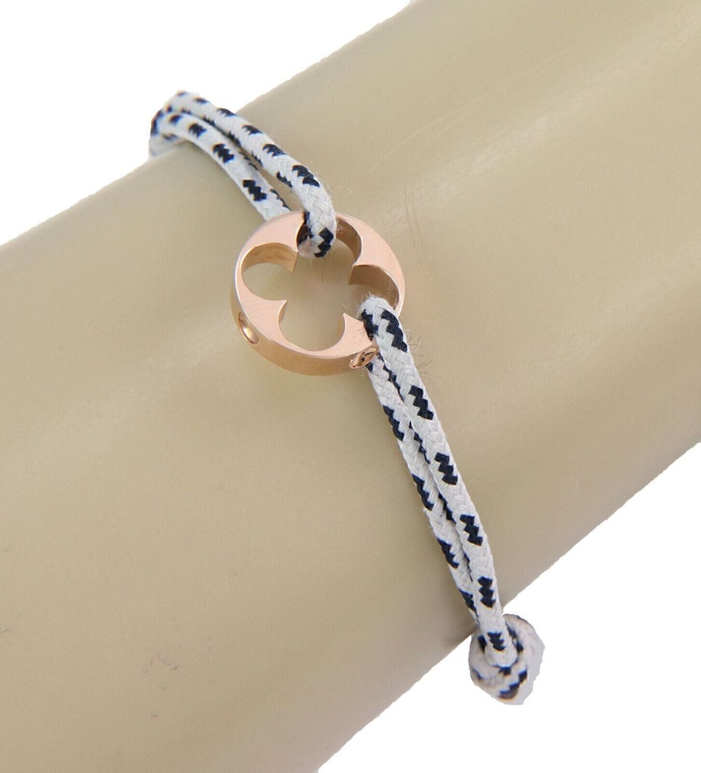 Empreinte 18k Rose Gold Charm Bracelet by Louis Vuitton with Black and White Cord: Empreinte 18k Rose Gold Charm Bracelet by Louis Vuitton with Black and White Cord This Louis Vuitton Empreinte charm bracelet features a sophisticated design crafted from 18k pink (rose) gold, paired