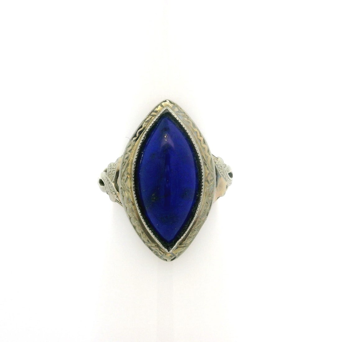 Art Deco 10k Yellow Gold Lapis Lazuli Cocktail Ring: Art Deco 10k Yellow Gold Lapis Lazuli Cocktail Ring This exquisite Antique Art Deco ring features a stunning marquise cabochon of natural lapis lazuli, showcasing a rich royal blue color. The stone is
