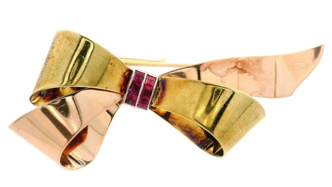 Tiffany & Co. 14k Rose Gold Ruby Ribbon Bow Brooch: Tiffany & Co. 14k Rose Gold Ruby Ribbon Bow Brooch This exquisite brooch from Tiffany & Co. features a charming ribbon bow design crafted from solid 14k rose and green gold. The centerpiece includes s