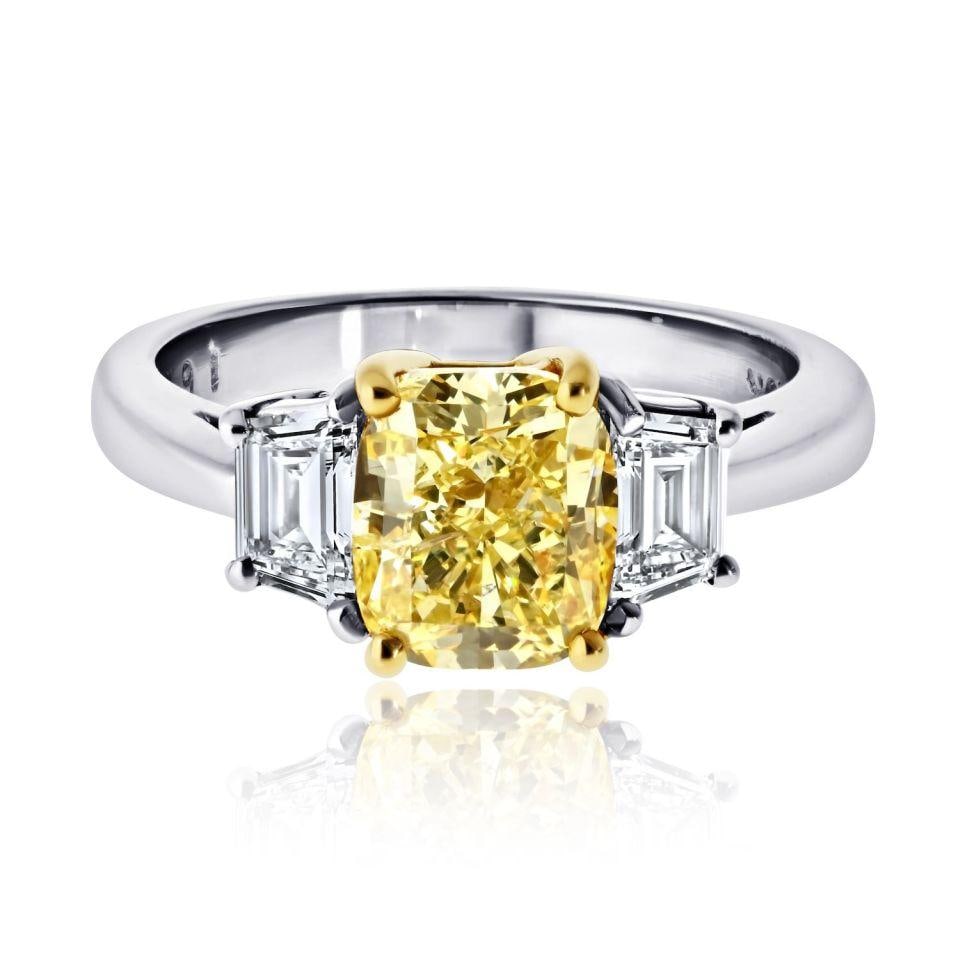 Fancy Yellow Diamond Ring in Platinum and 18K Yellow Gold 2.31 Carats: Fancy Yellow Diamond Ring in Platinum and 18K Yellow Gold 2.31 Carats This exquisite ring features a stunning 2.31 carat cushion cut diamond with a fancy intense yellow hue, certified by GIA. The diam