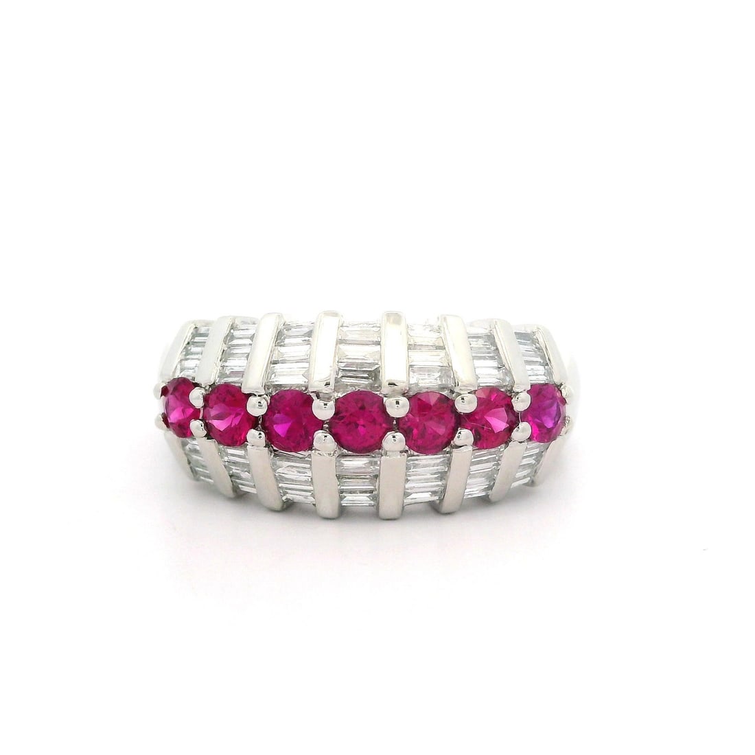 Platinum 1.18ctw Ruby Baguette Diamond Band Ring Size 6: Platinum 1.18ctw Ruby Baguette Diamond Band Ring Size 6 This exquisite band ring features a stunning arrangement of natural gemstones, including seven round brilliant cut rubies, each prong set to hig