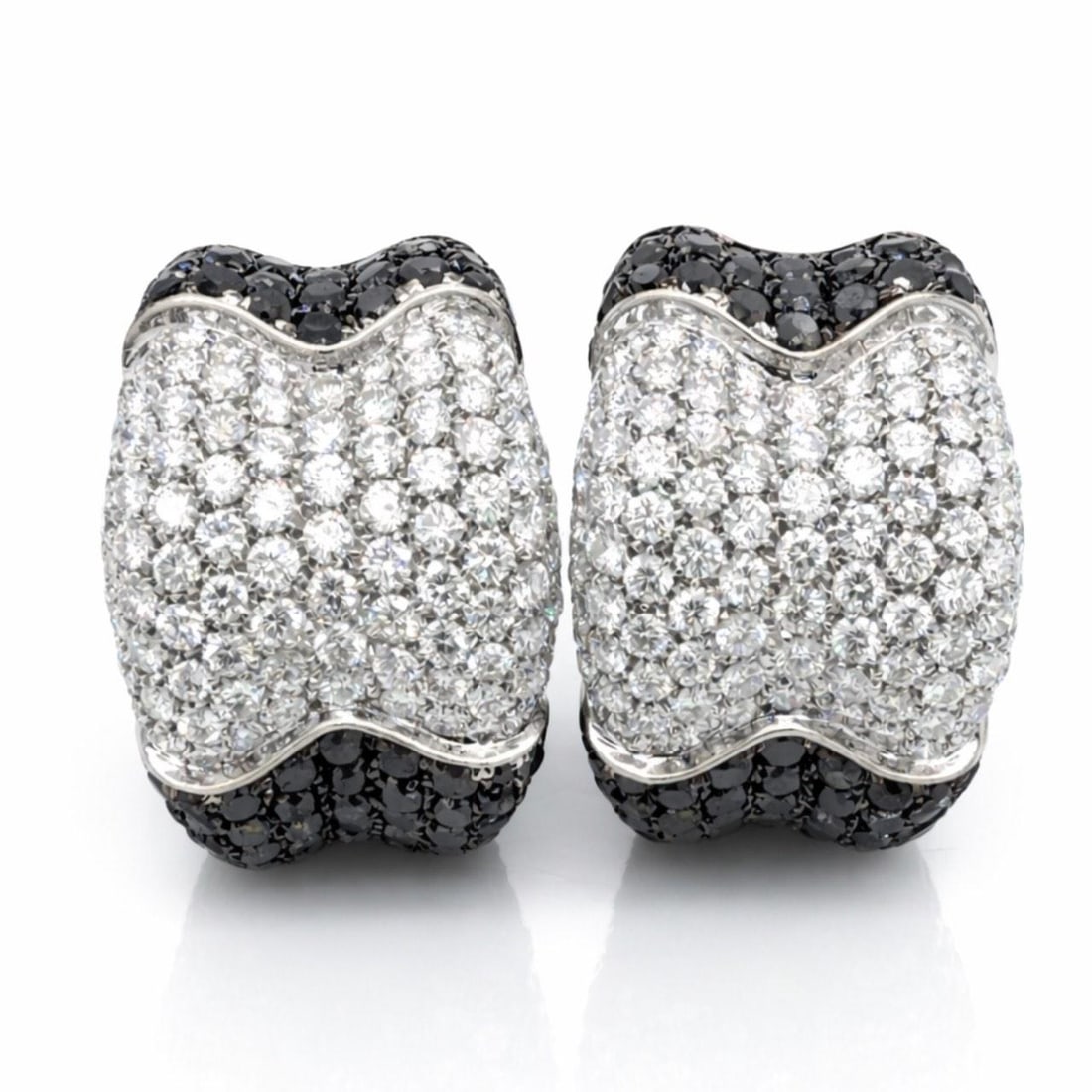 18K White Gold Earrings with Black and White Diamonds by De Grisogono: 18K White Gold Earrings with Black and White Diamonds by De Grisogono These De Grisogono earrings are crafted from 18K white gold and feature a striking combination of black and white diamonds. The ea