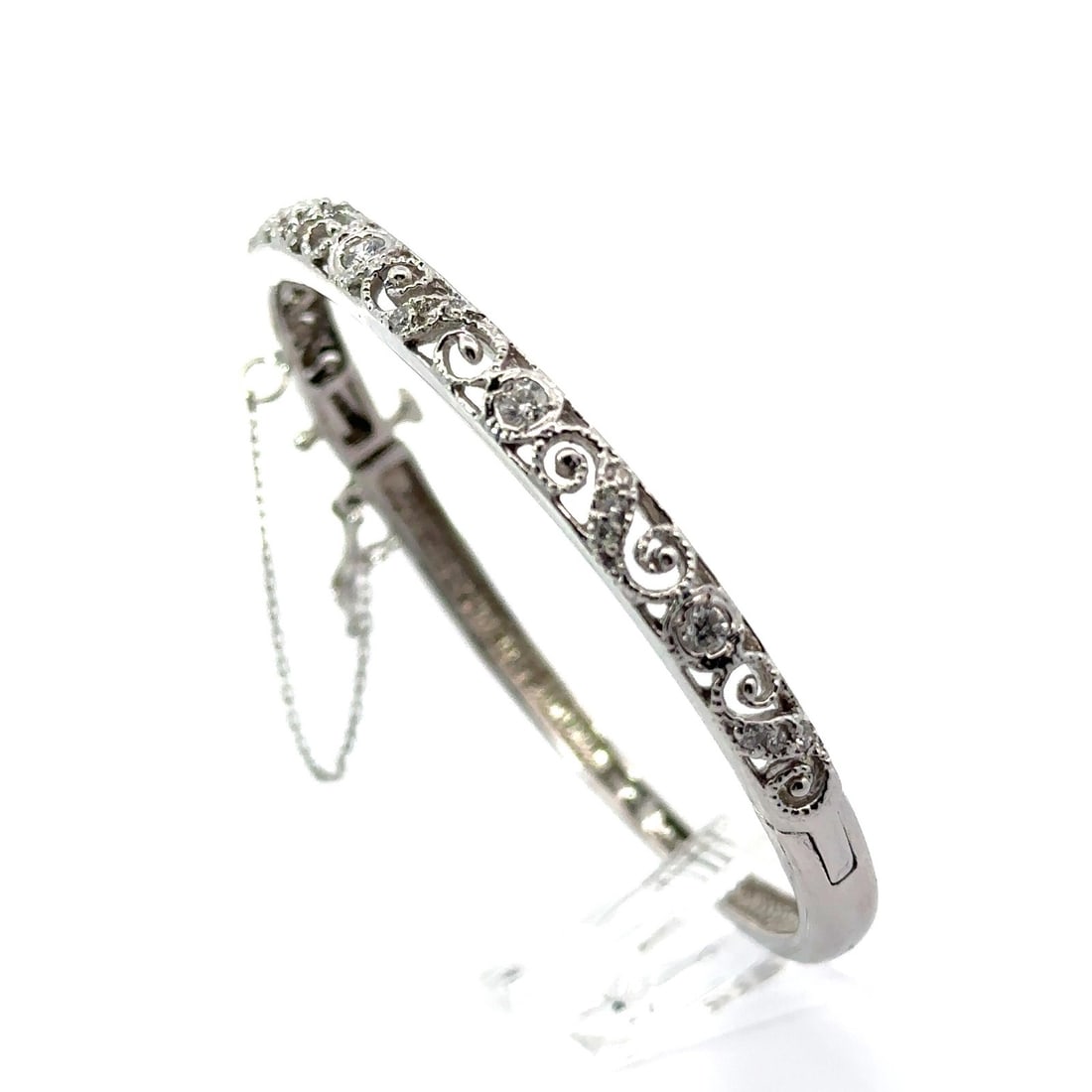 Elegant 13k White Gold Diamond Bangle Bracelet with Safety Chain: Elegant 13k White Gold Diamond Bangle Bracelet with Safety Chain This exquisite White Gold Diamond Hinged Open Work Bangle Bracelet features a stunning design with a secure safety chain. Meticulously