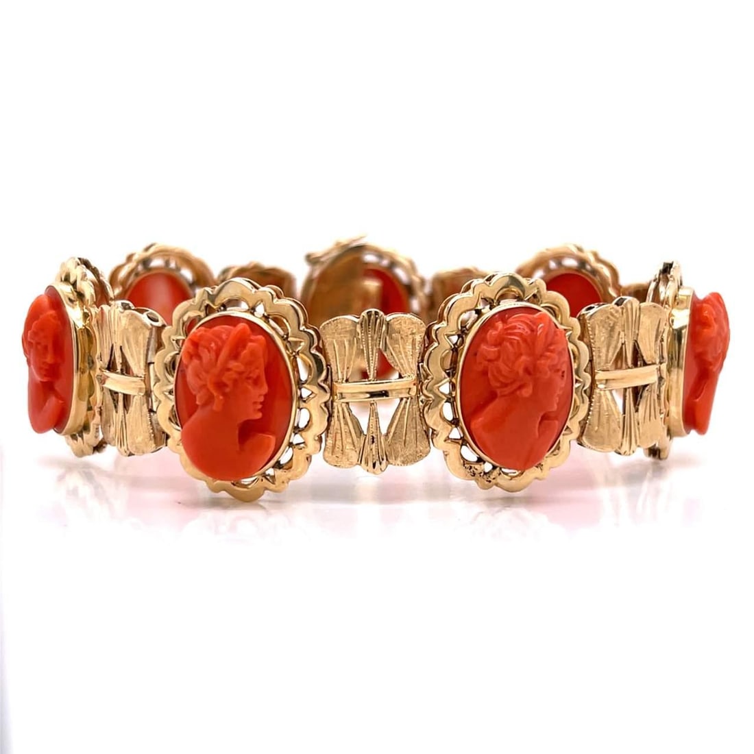 Vintage 1960's 18K Yellow Gold Coral Bracelet: Vintage 1960's 18K Yellow Gold Coral Bracelet This exquisite 1960's bracelet showcases a stunning design crafted from 18K yellow gold and adorned with vibrant coral. Weighing 36.3 grams, this piece of