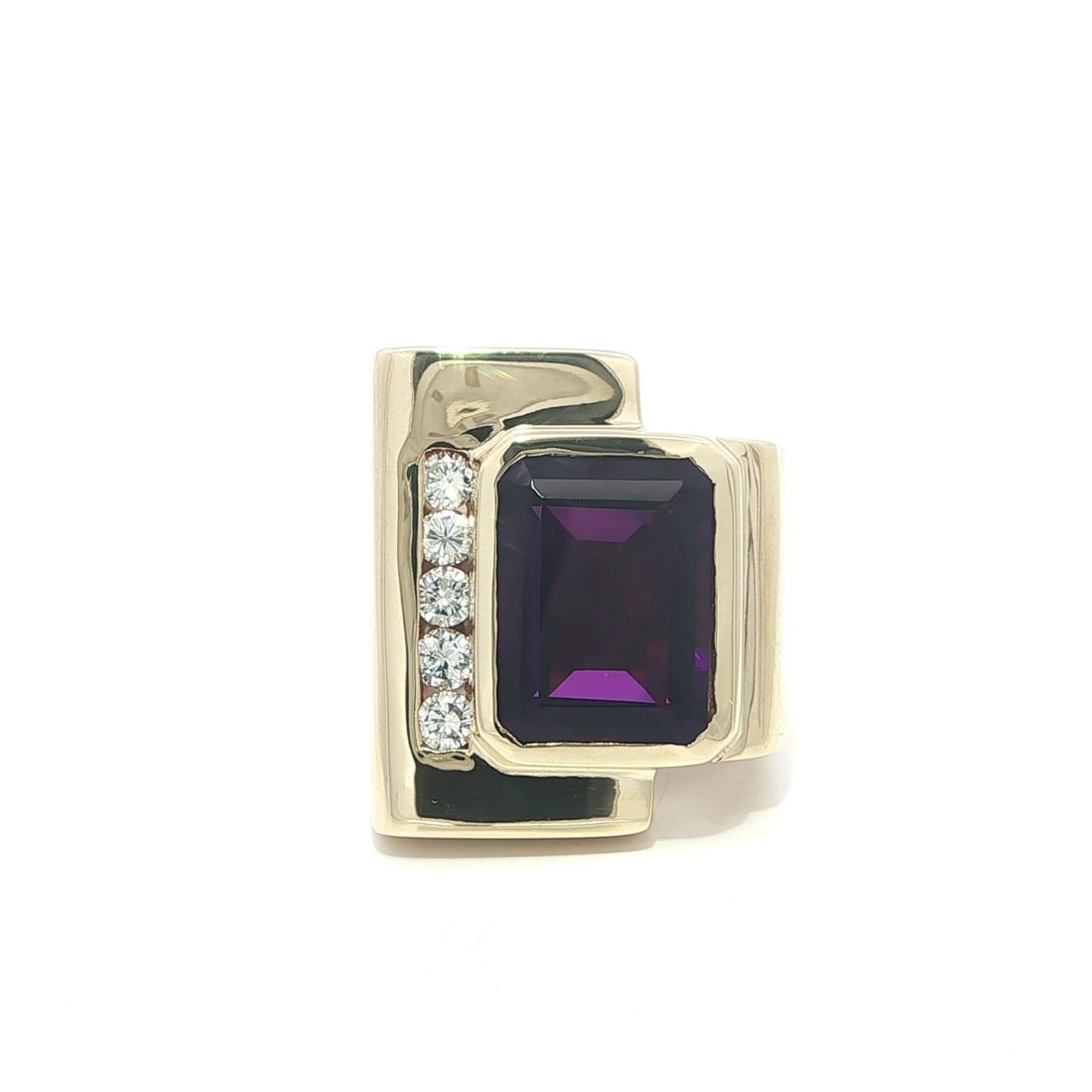 Cocktail Ring in 14k Yellow Gold with 7.33ct Amethyst and Diamond Accents: Cocktail Ring in 14k Yellow Gold with 7.33ct Amethyst and Diamond Accents This large geometric cocktail ring features a 7.33 carat natural emerald-cut amethyst in a deep royal purple hue, bezel set in
