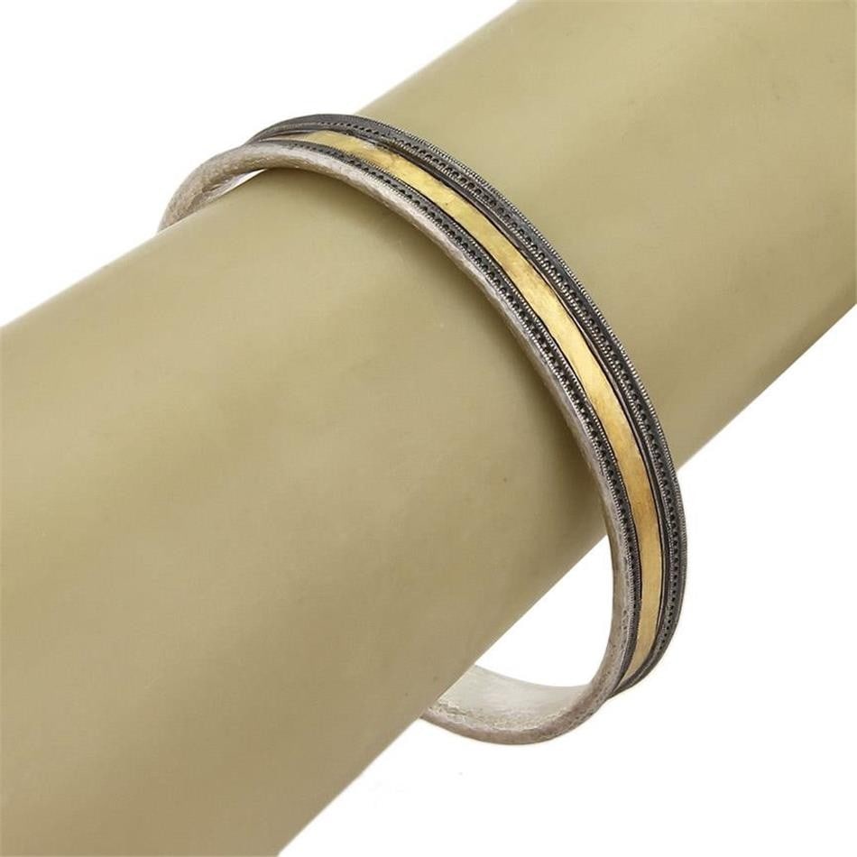 Lancelot Bangle Bracelet in 24k Gold and Sterling Silver by Gurhan: Lancelot Bangle Bracelet in 24k Gold and Sterling Silver by Gurhan This Gurhan Lancelot bangle bracelet features a sophisticated design crafted from 24k gold and sterling silver. Signed by Gurhan, it