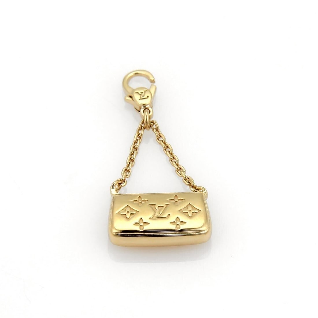 18k Yellow Gold Louis Vuitton Monogram Clutch Purse Charm Pendant: 18k Yellow Gold Louis Vuitton Monogram Clutch Purse Charm Pendant This Louis Vuitton de Monogram clutch purse charm pendant is crafted from 18k yellow gold and features the iconic monogram design. Mad