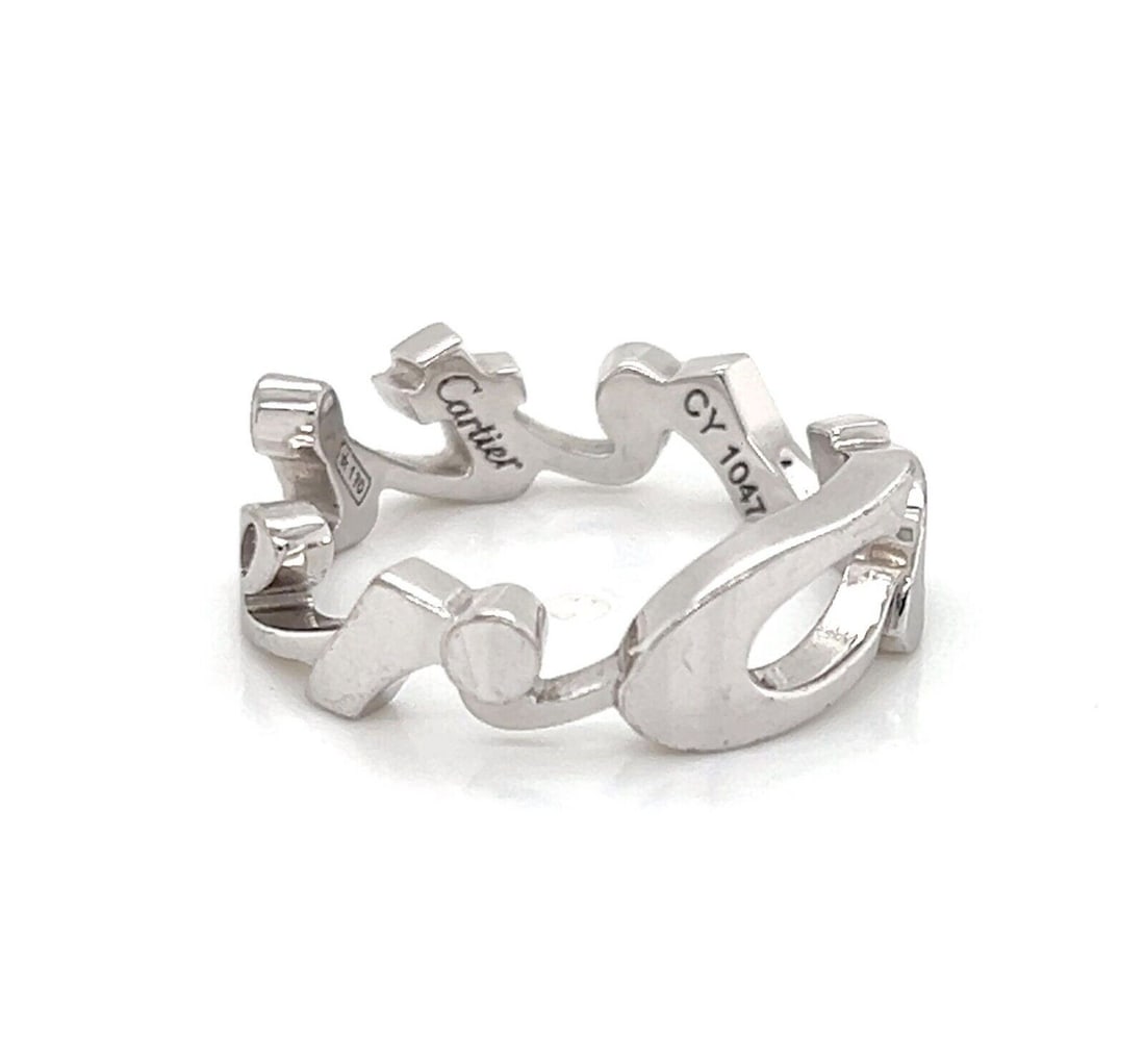 Size 5 18k White Gold Band Ring with Cartier Signature Script: Size 5 18k White Gold Band Ring with Cartier Signature Script This Cartier Signature band ring is crafted from 18k white gold and features an elegant script design. Signed by Cartier, the ring is pres