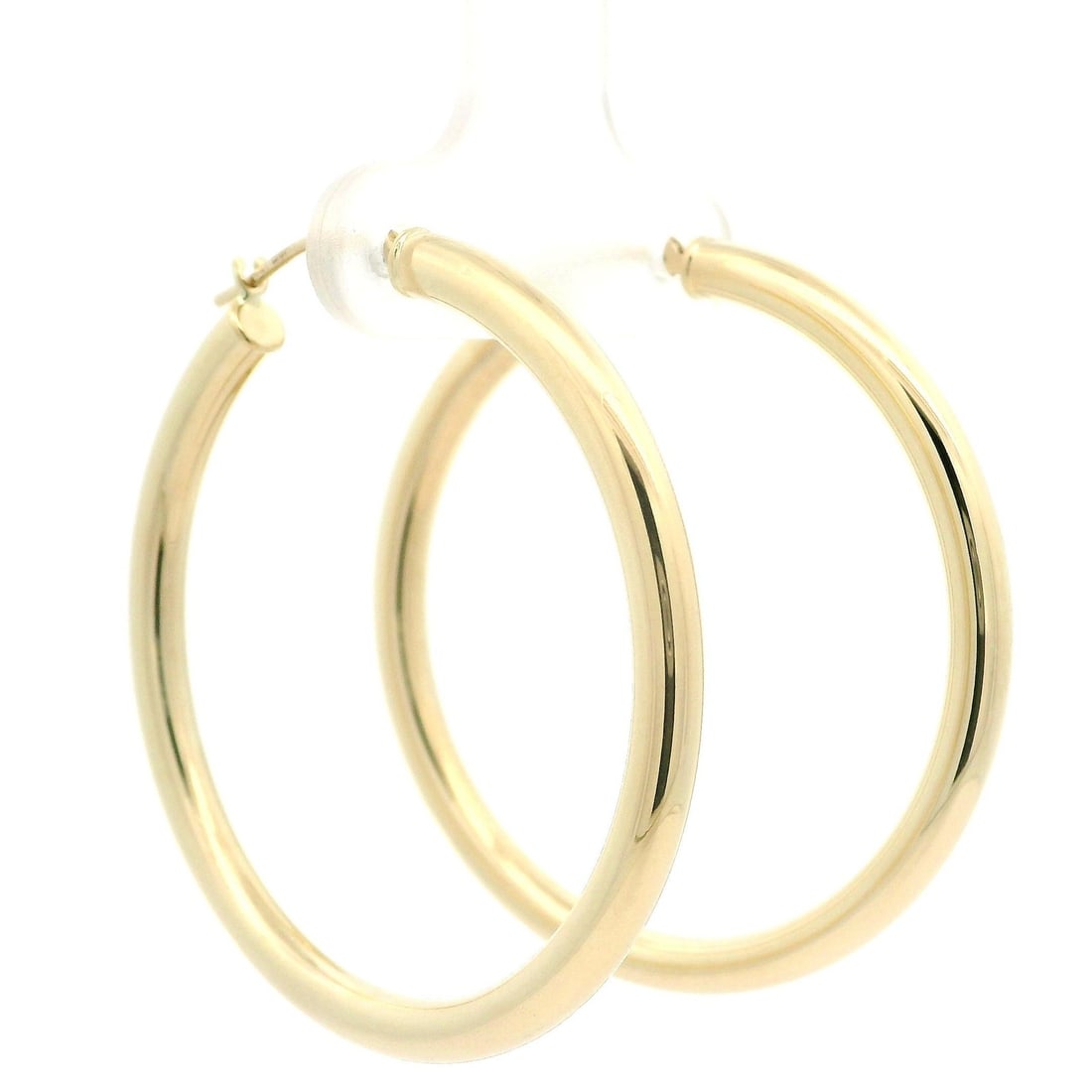 Large 38mm 14k Yellow Gold Round Tube Hoop Earrings: Large 38mm 14k Yellow Gold Round Tube Hoop Earrings Elevate your style with these Classic 14k Yellow Gold Round Tube Hoops. Crafted from solid 14k yellow gold, these large earrings feature a hollow de