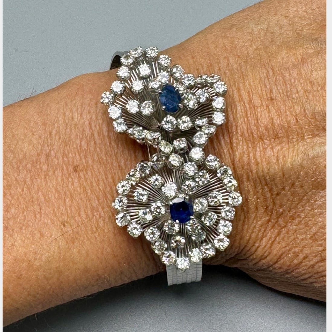 1950s 18K White Gold Bracelet with Sapphires and Diamonds 6.5 Inch: 1950s 18K White Gold Bracelet with Sapphires and Diamonds 6.5 Inch This 1950s bracelet is crafted from 18K white gold and features two sapphires with a total weight of approximately 2.00 carats. It is