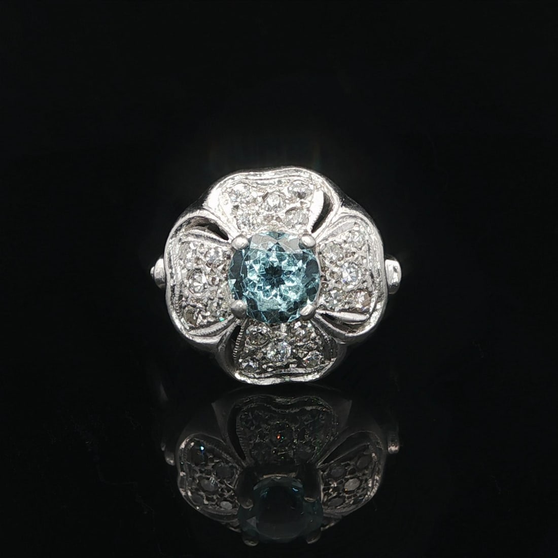 Platinum Cocktail Ring With Aquamarine And Pave Diamonds Four Leaf Clover Motif: Platinum Cocktail Ring With Aquamarine And Pave Diamonds Four Leaf Clover Motif This antique cocktail ring features a 1.24 carat natural round brilliant cut aquamarine in a light blue hue, prong set a