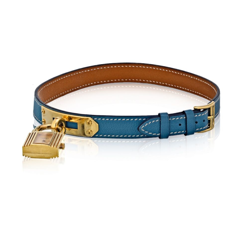 Hermes Kelly PM Double Tour Stainless Steel Blue Gold Tone Watch: Hermes Kelly PM Double Tour Stainless Steel Blue Gold Tone Watch This exquisite Hermes Stainless Steel Kelly PM Double Tour Watch features a stunning gold tone dial and a vibrant blue bracelet that wr