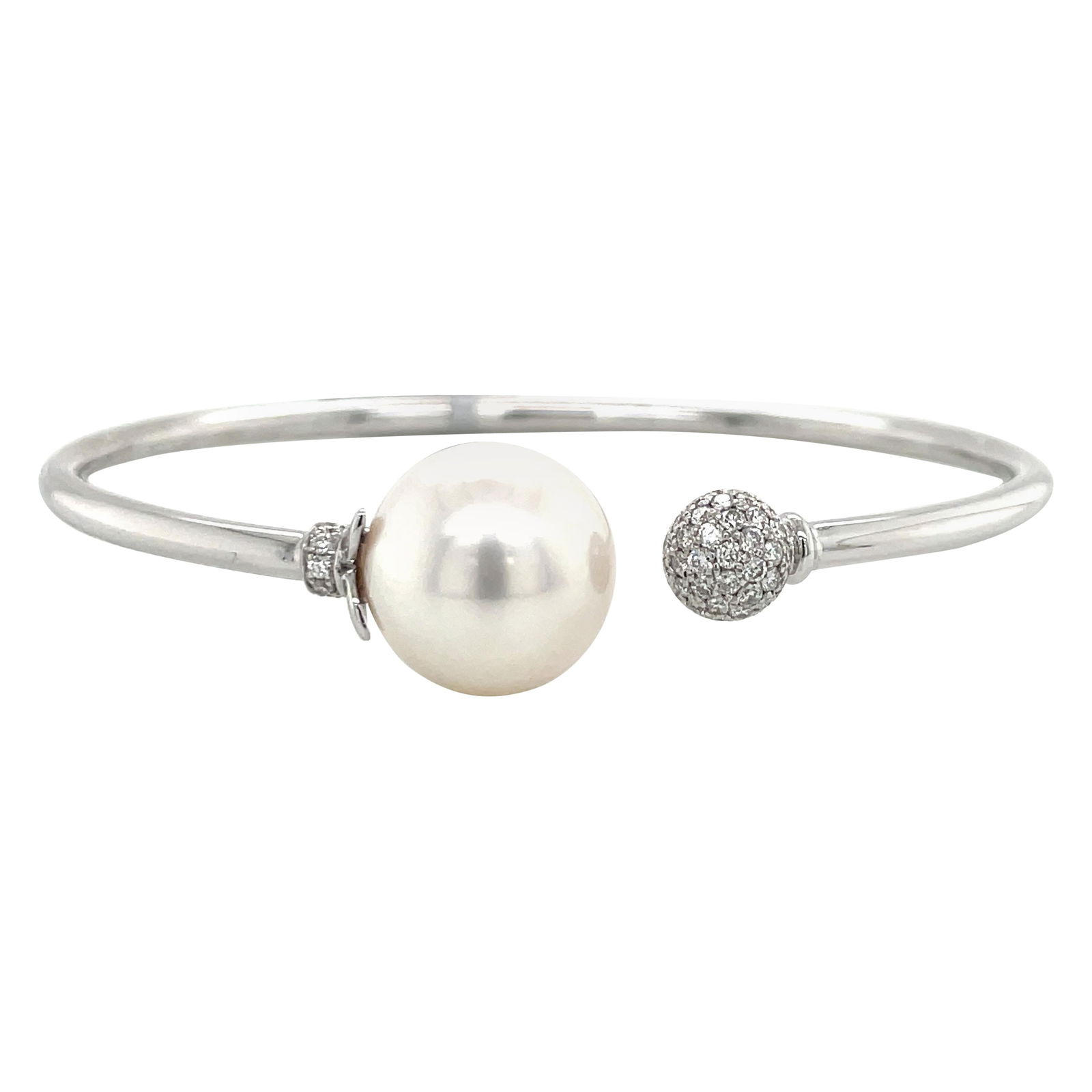 18K White Gold Diamond Cuff Bangle with South Sea Pearl 0.40 Carats: 18K White Gold Diamond Cuff Bangle with South Sea Pearl 0.40 Carats This exquisite 18 Karat White Gold Open Bangle Cuff showcases a stunning South Sea Pearl measuring 12-13 MM and is adorned with a di