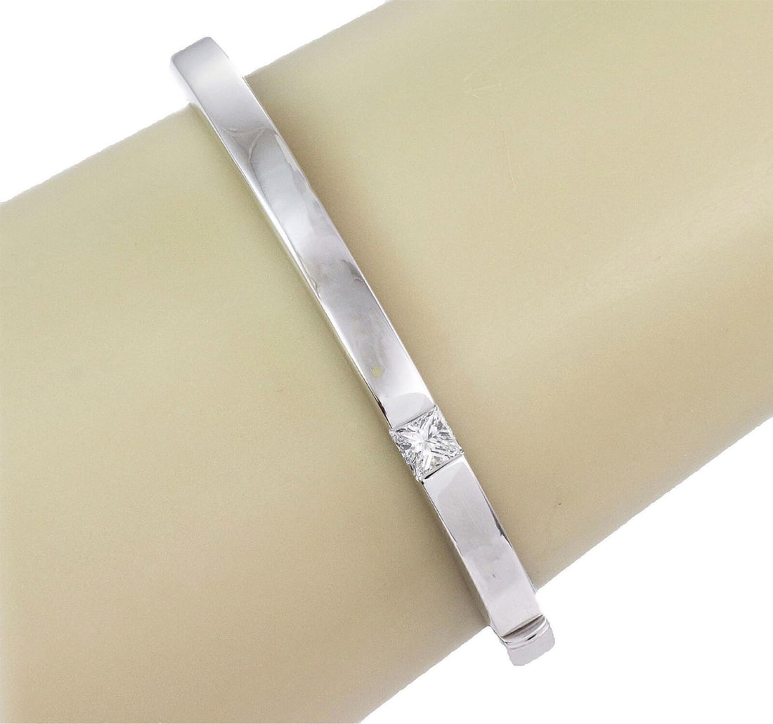 Cartier Tank 18k White Gold Bangle with Princess Cut Diamond Size 16: Cartier Tank 18k White Gold Bangle with Princess Cut Diamond Size 16 This authentic Cartier Tank bangle bracelet is crafted from solid 18k white gold and features a princess-cut diamond accent. The de