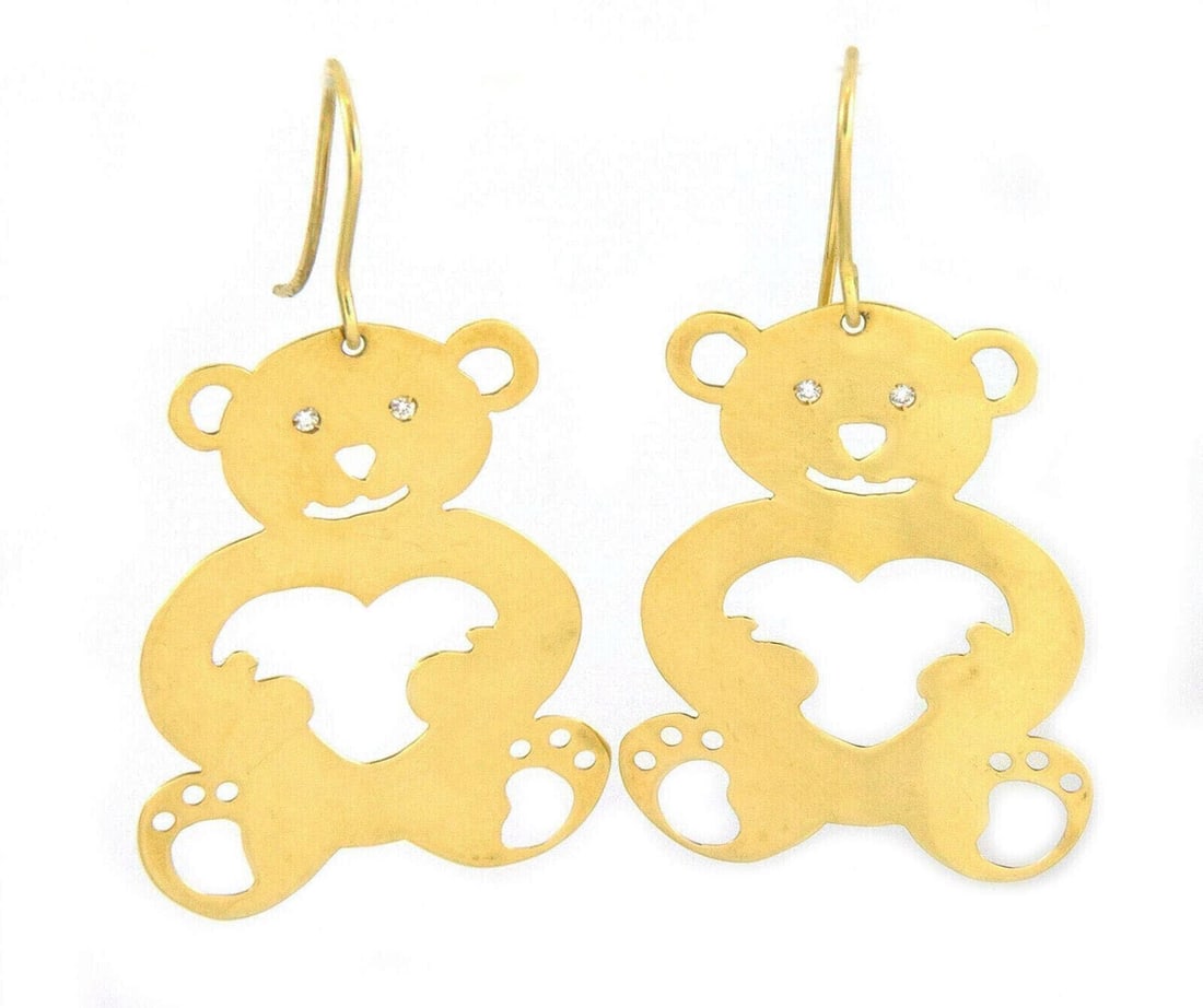 Diamond Teddy Bear Dangle Earrings in 18k Yellow Gold by Roberto Coin: Diamond Teddy Bear Dangle Earrings in 18k Yellow Gold by Roberto Coin These Roberto Coin earrings feature a cut-out teddy bear design, crafted in 18k yellow gold. The dangle earrings are accented with