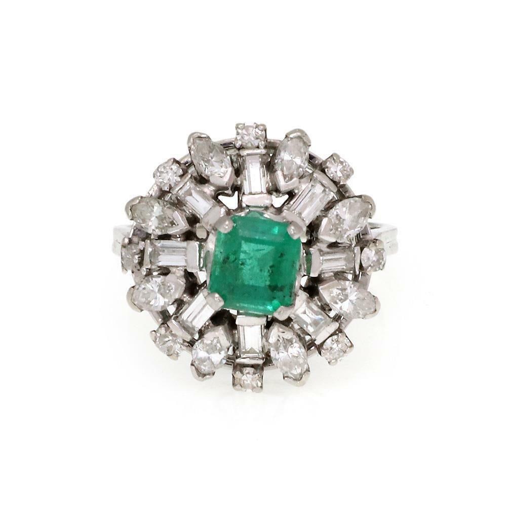 14k White Gold Vintage Diamond Emerald Cocktail Ring: 14k White Gold Vintage Diamond Emerald Cocktail Ring This exquisite vintage cocktail ring showcases a stunning design crafted from 14k white gold. The ring features a high floral bridge adorned with m