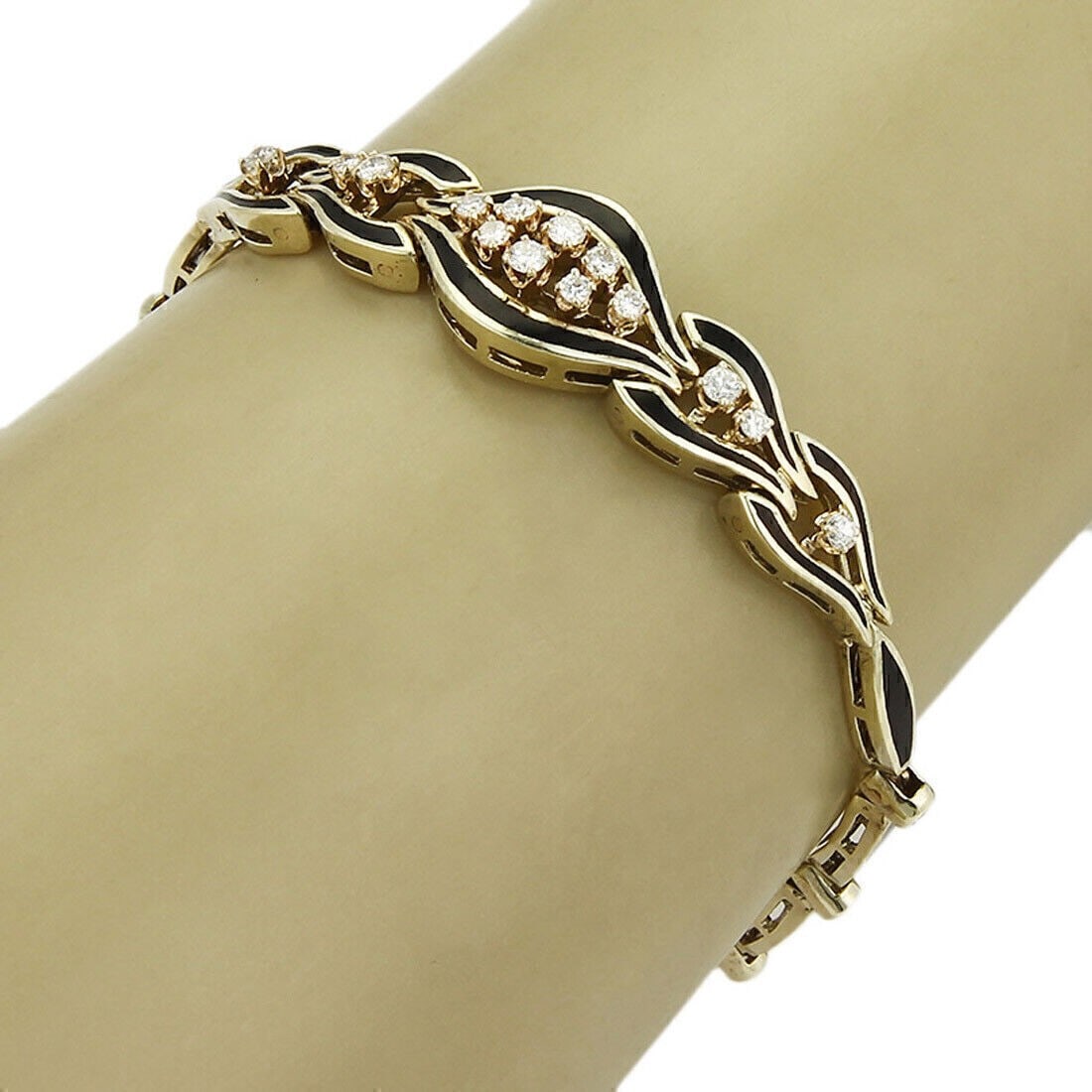 14k Yellow Gold Link Bracelet with Diamond and Enamel Detailing: 14k Yellow Gold Link Bracelet with Diamond and Enamel Detailing This bracelet is crafted from 14k yellow gold and features intricately designed links adorned with diamond and enamel accents. The bangl