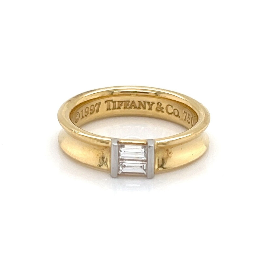 18k Yellow Gold Baguette Diamond Channel Band by Tiffany Size 6: 18k Yellow Gold Baguette Diamond Channel Band by Tiffany Size 6 This 18k yellow gold ring by Tiffany & Co. features a channel set of baguette diamonds, offering a refined and elegant look. The ring is