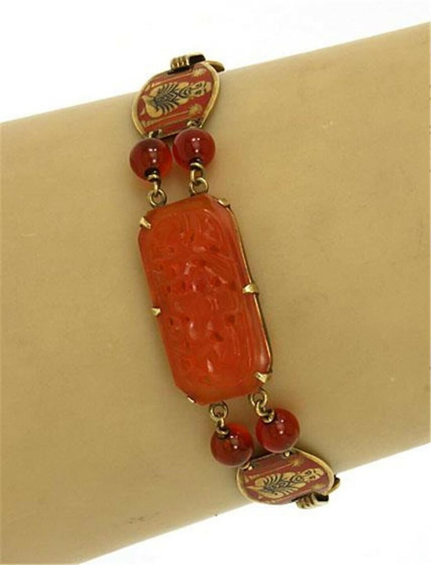 Vintage 14k Gold Bracelet with Carnelian and Enamel Buddha Charm: Vintage 14k Gold Bracelet with Carnelian and Enamel Buddha Charm This vintage bracelet is crafted from solid 14k yellow gold and features a link-style design centered on a Buddha charm. The charm is a