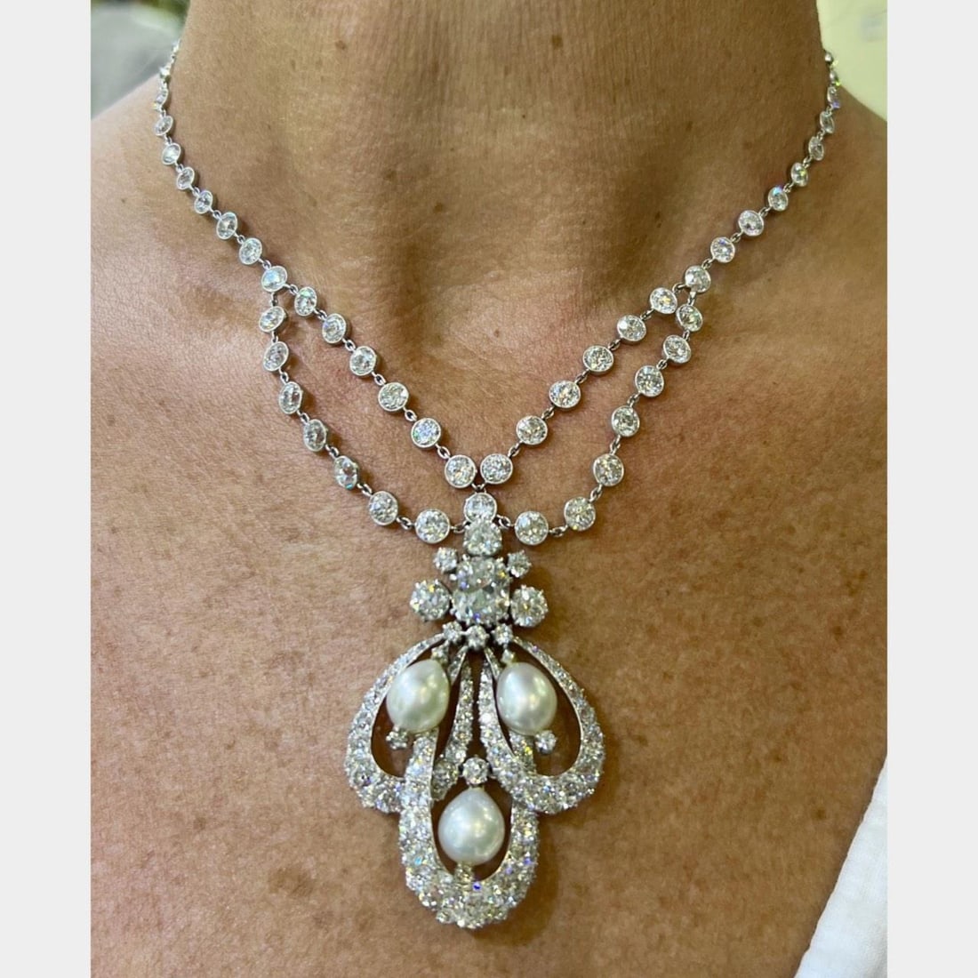 GIA Certified Art Deco Platinum Necklace with Diamonds and Pearls: GIA Certified Art Deco Platinum Necklace with Diamonds and Pearls This exquisite Art Deco necklace is crafted in platinum and features a stunning array of gemstones. At its center lies an approximatel