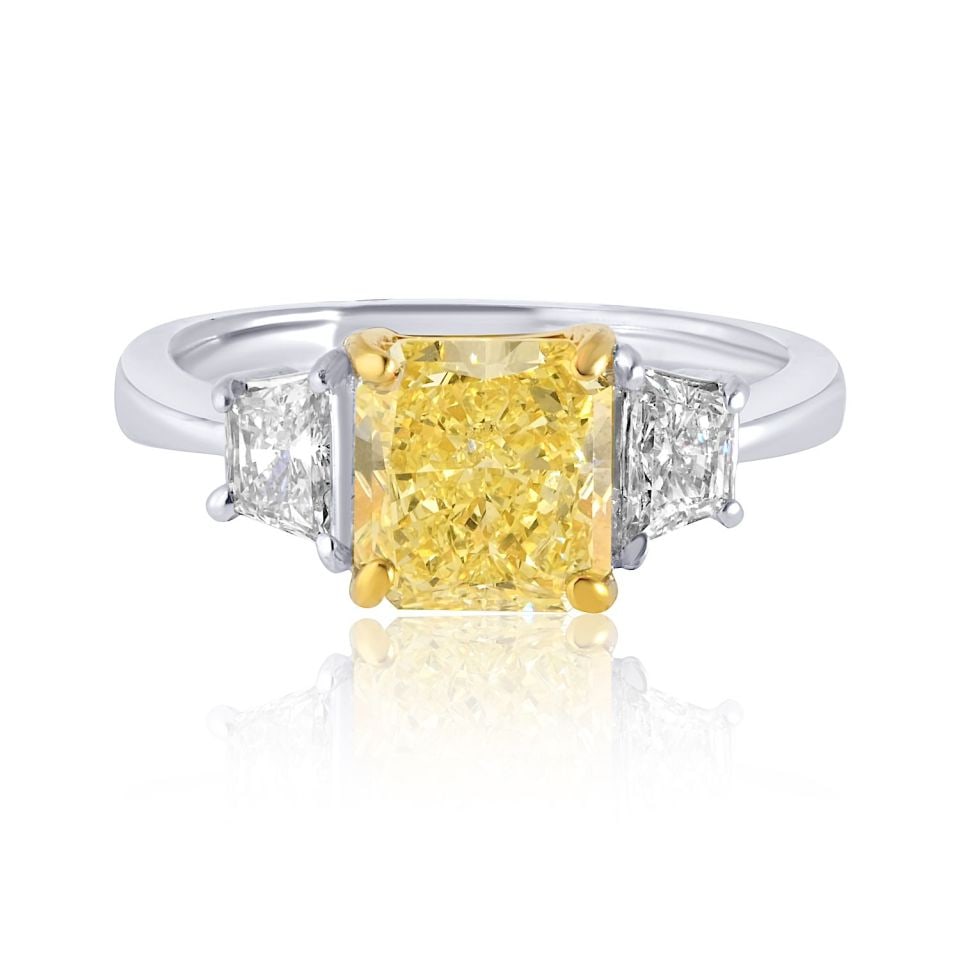 2.07 Carat GIA Certified Fancy Yellow Three Stone Engagement Ring: 2.07 Carat GIA Certified Fancy Yellow Three Stone Engagement Ring This exquisite handmade engagement ring showcases a stunning 2.07-carat radiant cut diamond, boasting a captivating Fancy Yellow hue c