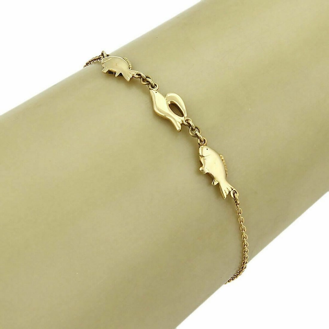 Mikimoto 18k Gold Chain Bracelet with Three Fish Charms: Mikimoto 18k Gold Chain Bracelet with Three Fish Charms This Mikimoto bracelet features a chain design crafted from 18k yellow gold and is adorned with three fish-shaped charms. The bracelet is signed