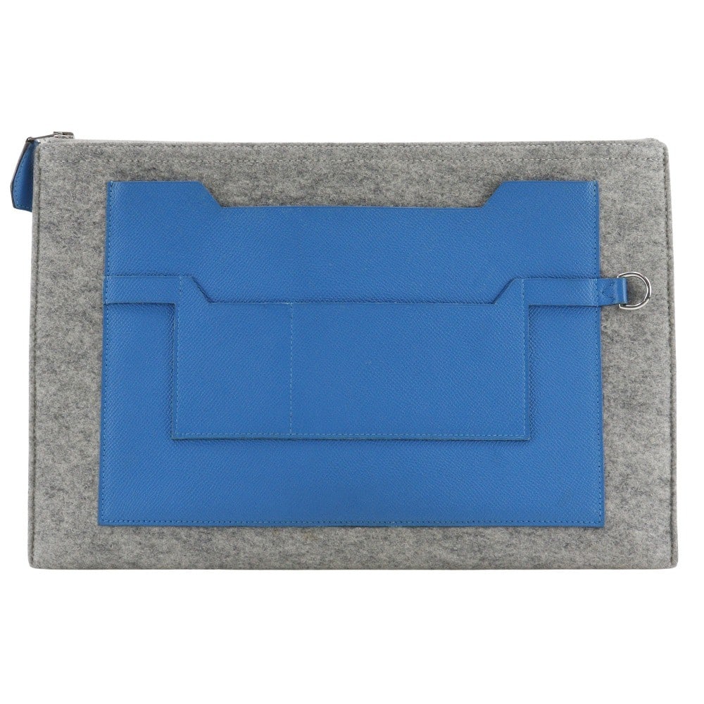 Toodoo Wool and Epsom Blue Pouch by Hermes: Toodoo Wool and Epsom Blue Pouch by Hermes The Hermes Toodoo Pouch is crafted from blue wool, offering a stylish and functional accessory suitable for all genders. This pouch features minor exterior s