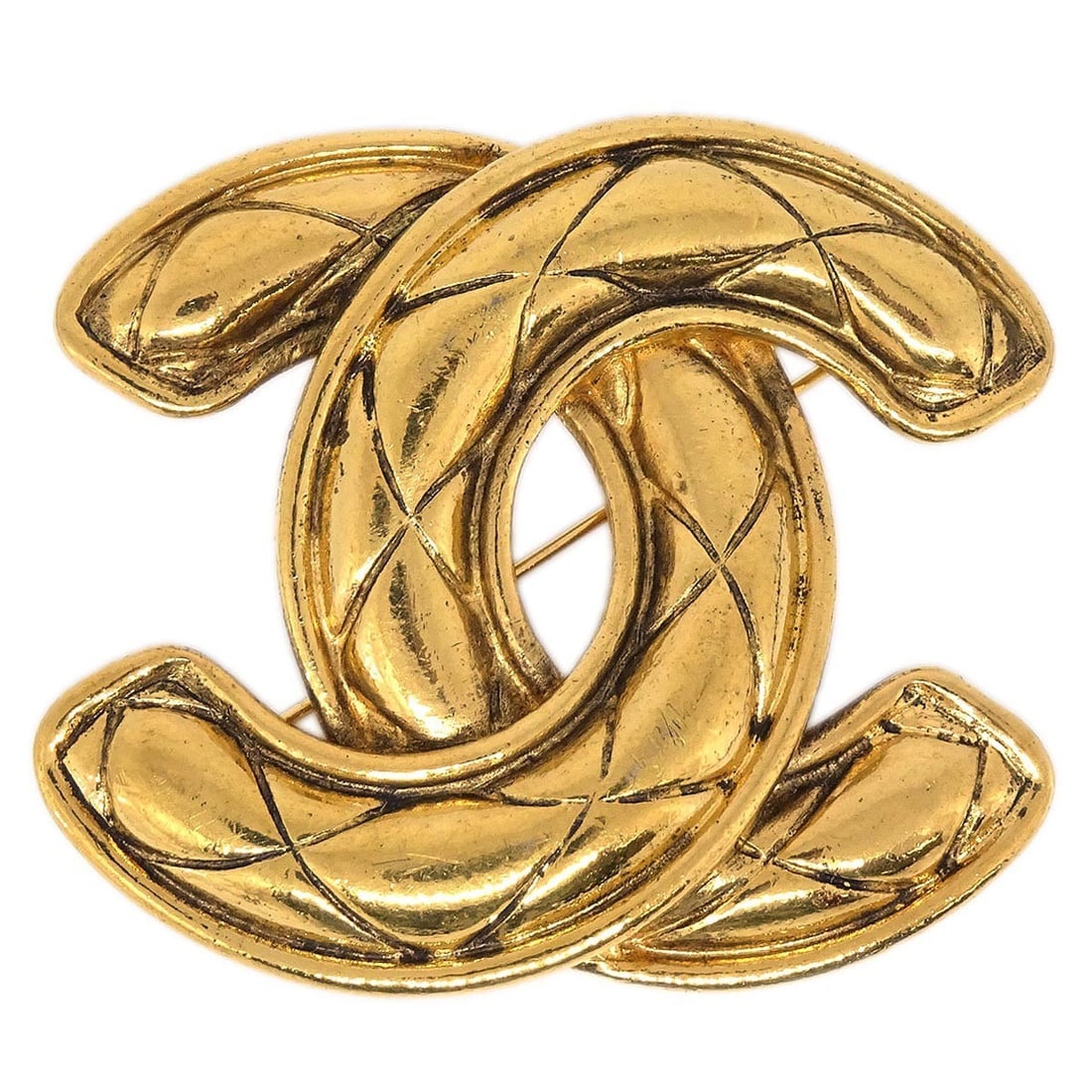 Large Gold-Plated Chanel CC Logo Quilted Brooch Pin: Large Gold-Plated Chanel CC Logo Quilted Brooch Pin This large Chanel brooch features the iconic quilted CC logo in a gold-plated finish. Made in France, it is designed as a classic logo accessory. Th