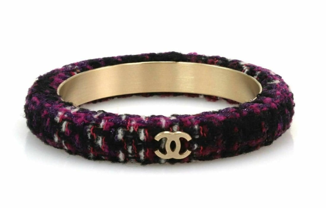 Chanel Tweed Bangle Bracelet Purple Black Fabric Gold Tone Logo: Chanel Tweed Bangle Bracelet Purple Black Fabric Gold Tone Logo This authentic Chanel bangle from the Tweed collection showcases a blend of dark and light purple tones interwoven with black fabric in