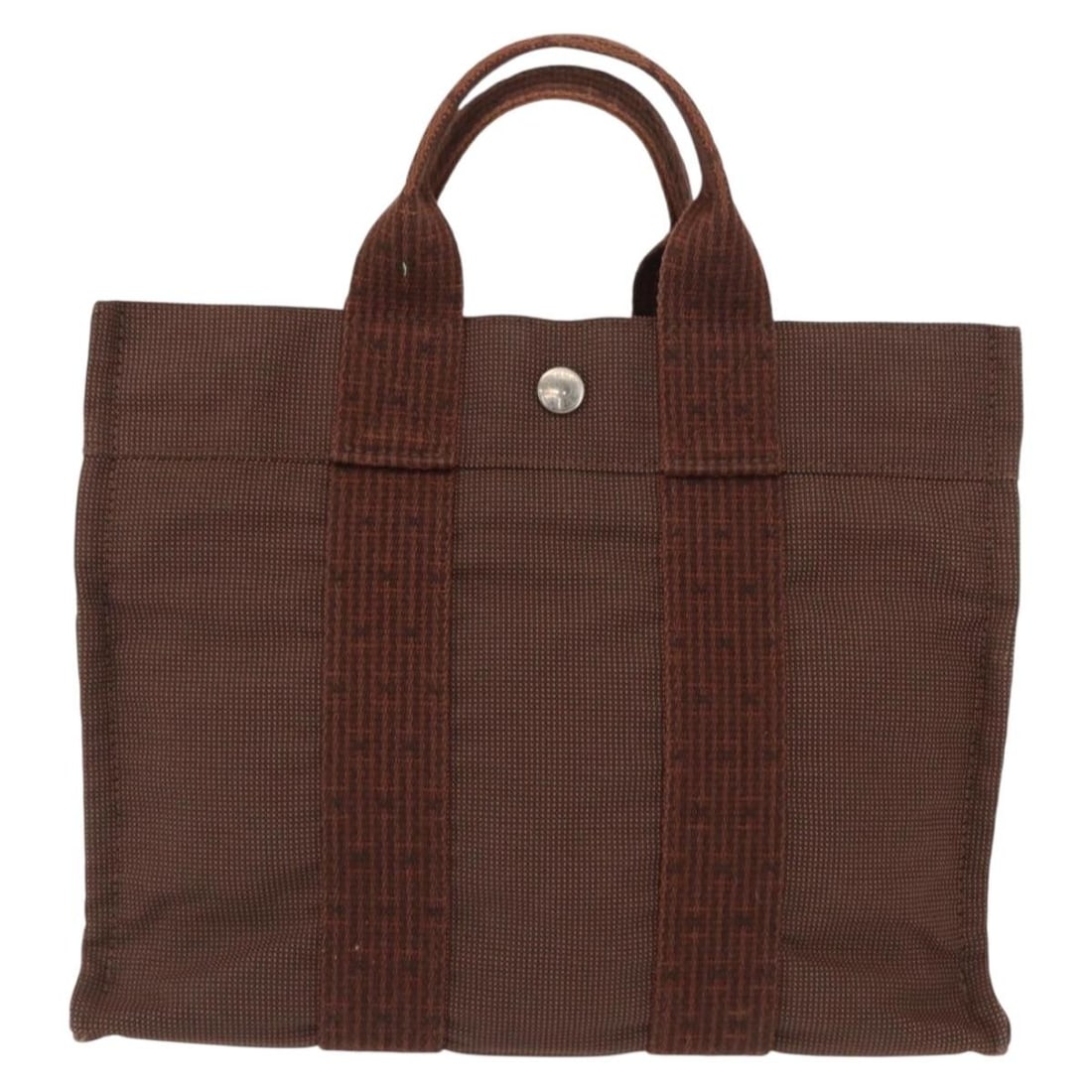 Fourre-tout Herline Canvas Tote Bag by Hermes in Brown: Fourre-tout Herline Canvas Tote Bag by Hermes in Brown The Hermes Fourre-tout Herline is a brown canvas bag designed for women. It features a spacious interior and sturdy handles. The bag shows signs