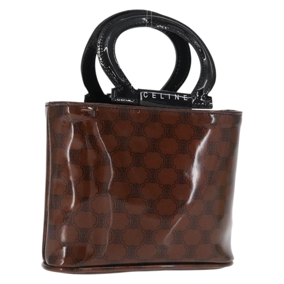 Brown Macadam Canvas Vinyl Handbag by CELINE: Brown Macadam Canvas Vinyl Handbag by CELINE This CELINE hand bag features the signature Macadam canvas with vinyl material in brown. The bag is designed with a compact shape and includes a top handle