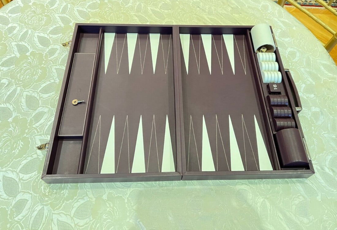 Asprey Leather Backgammon Set with Lock and Key: Asprey Leather Backgammon Set with Lock and Key Experience the elegance of this exquisite leather backgammon set by Asprey of London, featuring a secure lock and key. Crafted with meticulous attention