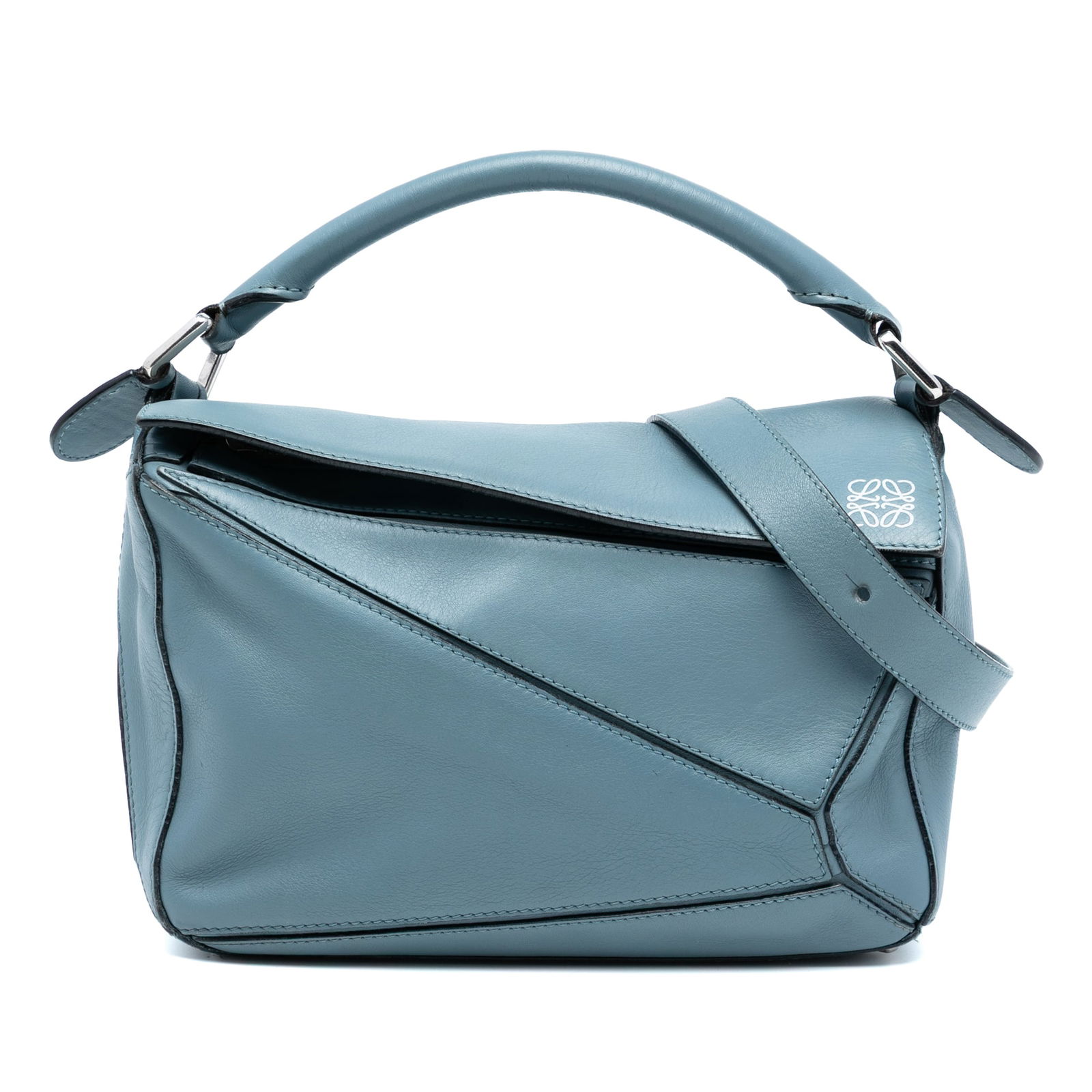 Loewe Puzzle Small Blue Leather Satchel Bag with Top Handle and Strap: Loewe Puzzle Small Blue Leather Satchel Bag with Top Handle and Strap This LOEWE Small Calfskin Puzzle Satchel showcases a distinctive design with blue leather, a rolled leather top handle, and a deta