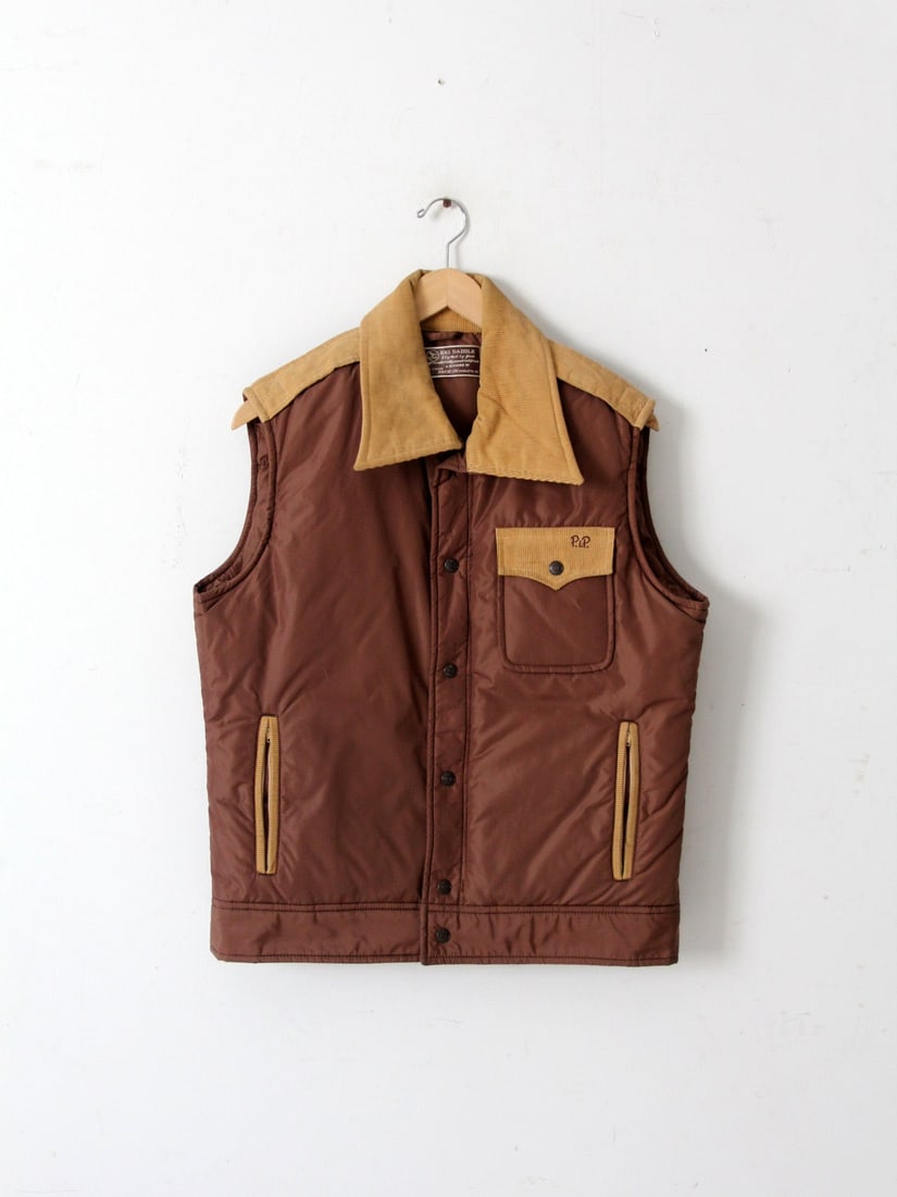 Vintage 1970s Ski Daddle Vest Dark Brown Corduroy with Embroidered Initials: Vintage 1970s Ski Daddle Vest Dark Brown Corduroy with Embroidered Initials This vintage 1970s ski vest, known as the "Ski Daddle," showcases a stylish dark brown body complemented by a tan corduroy c