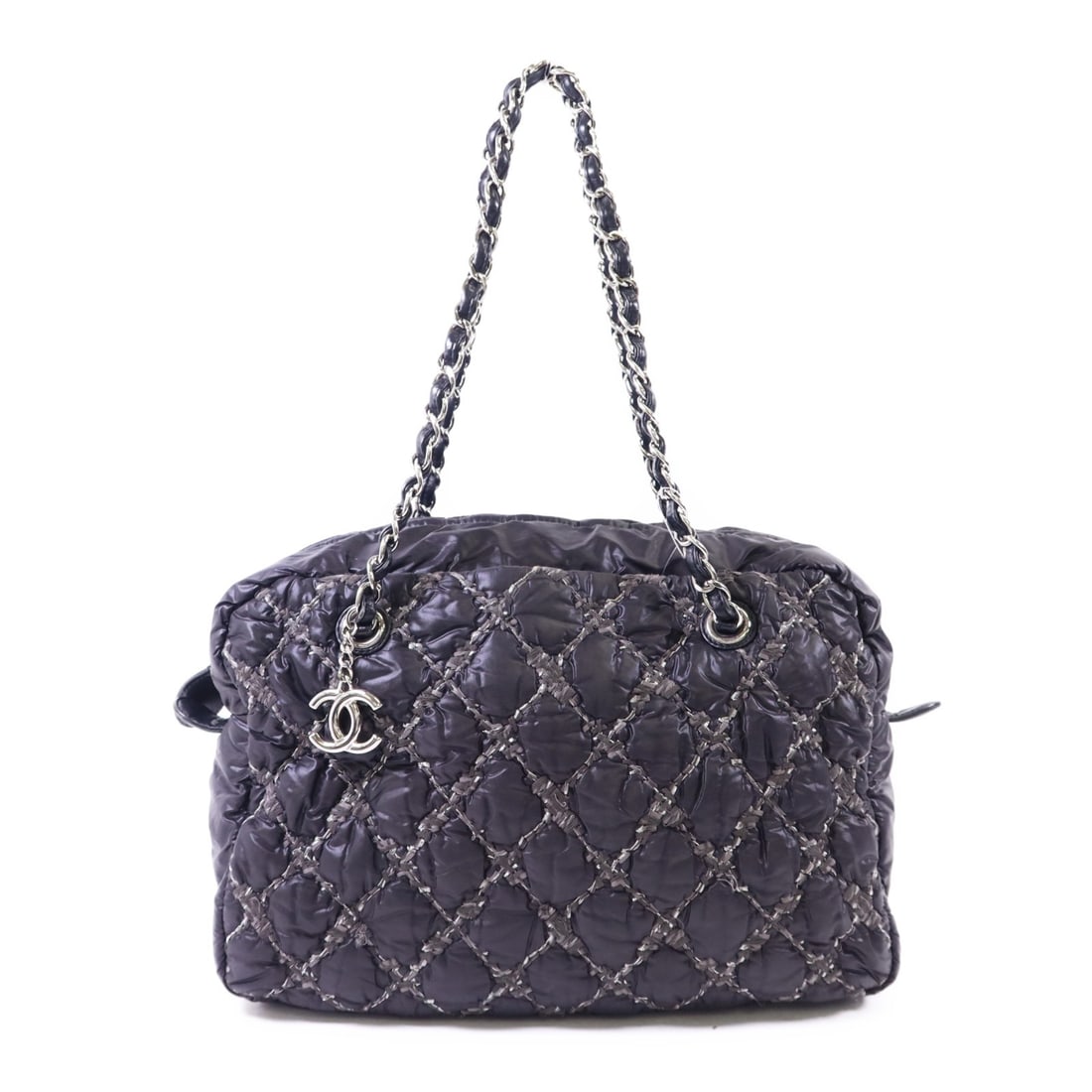 Chanel Nylon Tote CC Logo Silver Hardware in Black: Chanel Nylon Tote CC Logo Silver Hardware in Black This CHANEL tote bag is crafted from durable nylon in a sophisticated gray color. Featuring the iconic CC logo and silver-tone hardware, it is design