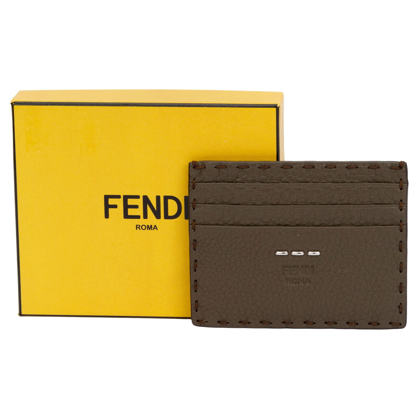 Fendi Selleria Etoupe Leather Card Holder with 6 Slots: Fendi Selleria Etoupe Leather Card Holder with 6 Slots Introducing the Fendi Selleria Card Holder in a sophisticated Etoupe leather. This stylish accessory features a sleek design with meticulously st