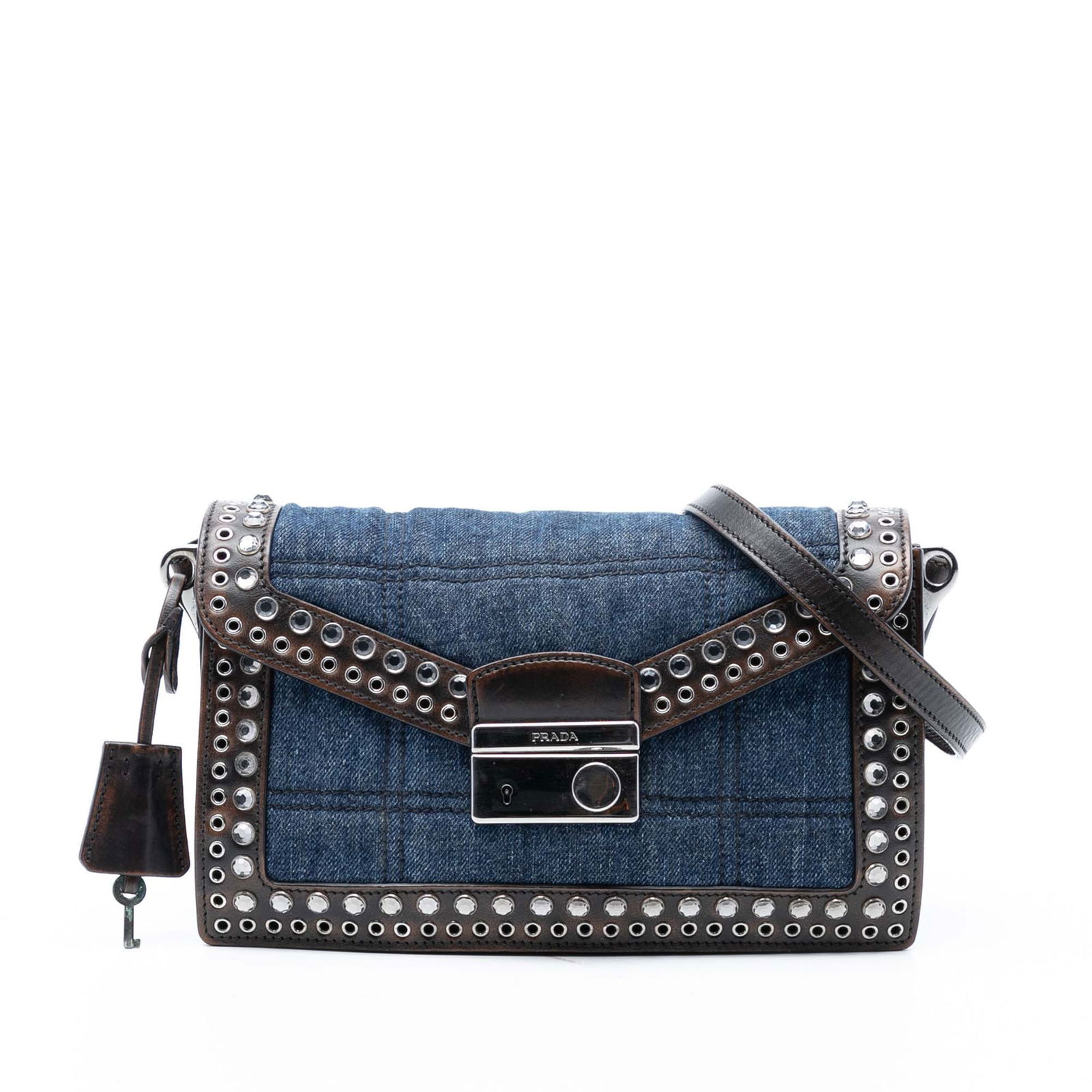 Prada Studded Denim Sound Lock Blue Crossbody Bag with Leather Trim: Prada Studded Denim Sound Lock Blue Crossbody Bag with Leather Trim This Prada crossbody bag features a blue denim body with studded leather trim, an adjustable flat leather strap, and a front flap se