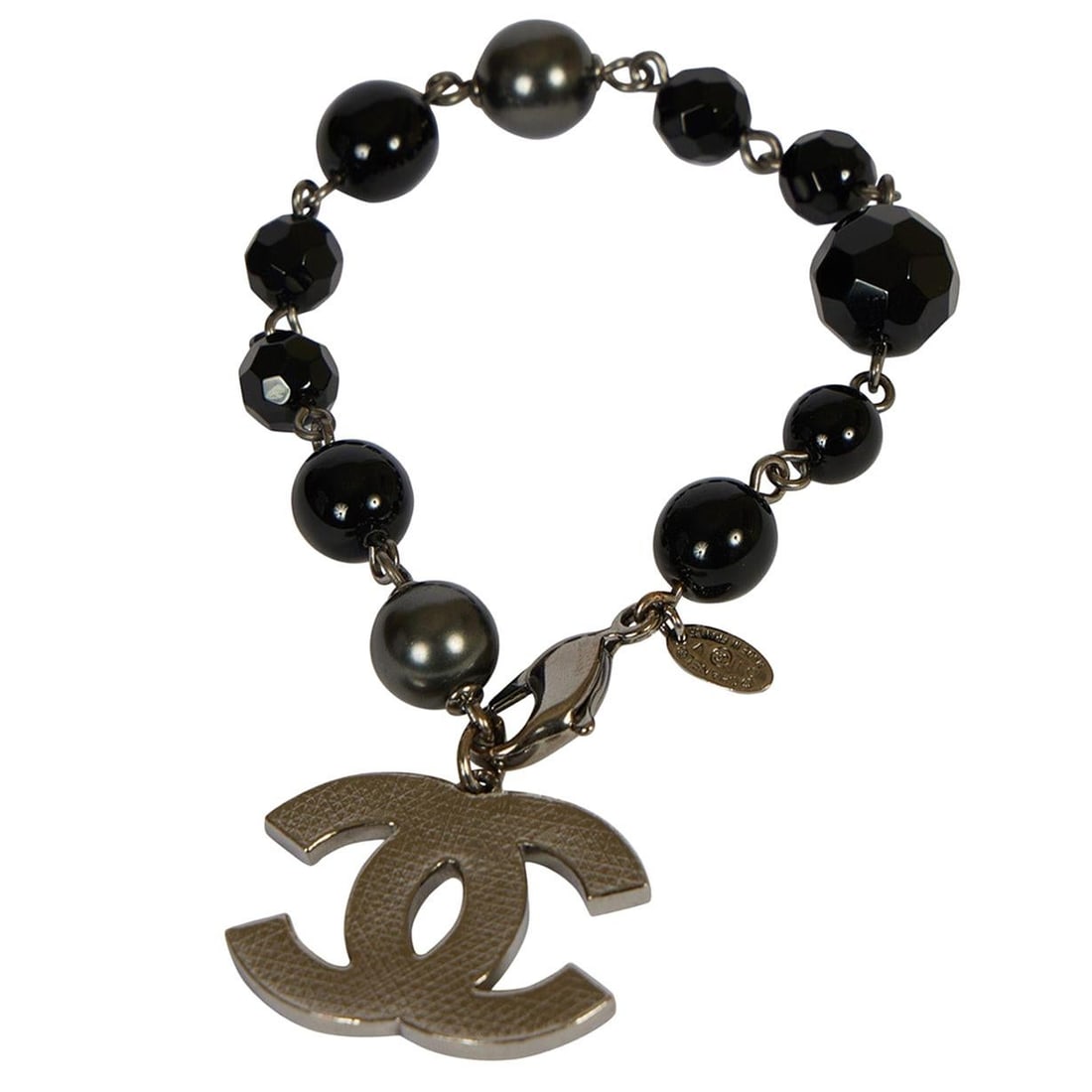 Chanel 2011 Black Gripoix Gunmetal Bracelet with CC Charm: Chanel 2011 Black Gripoix Gunmetal Bracelet with CC Charm This exquisite Chanel bracelet features a stunning combination of black gripoix and a gunmetal chain, showcasing a chic CC dangle charm. Craft
