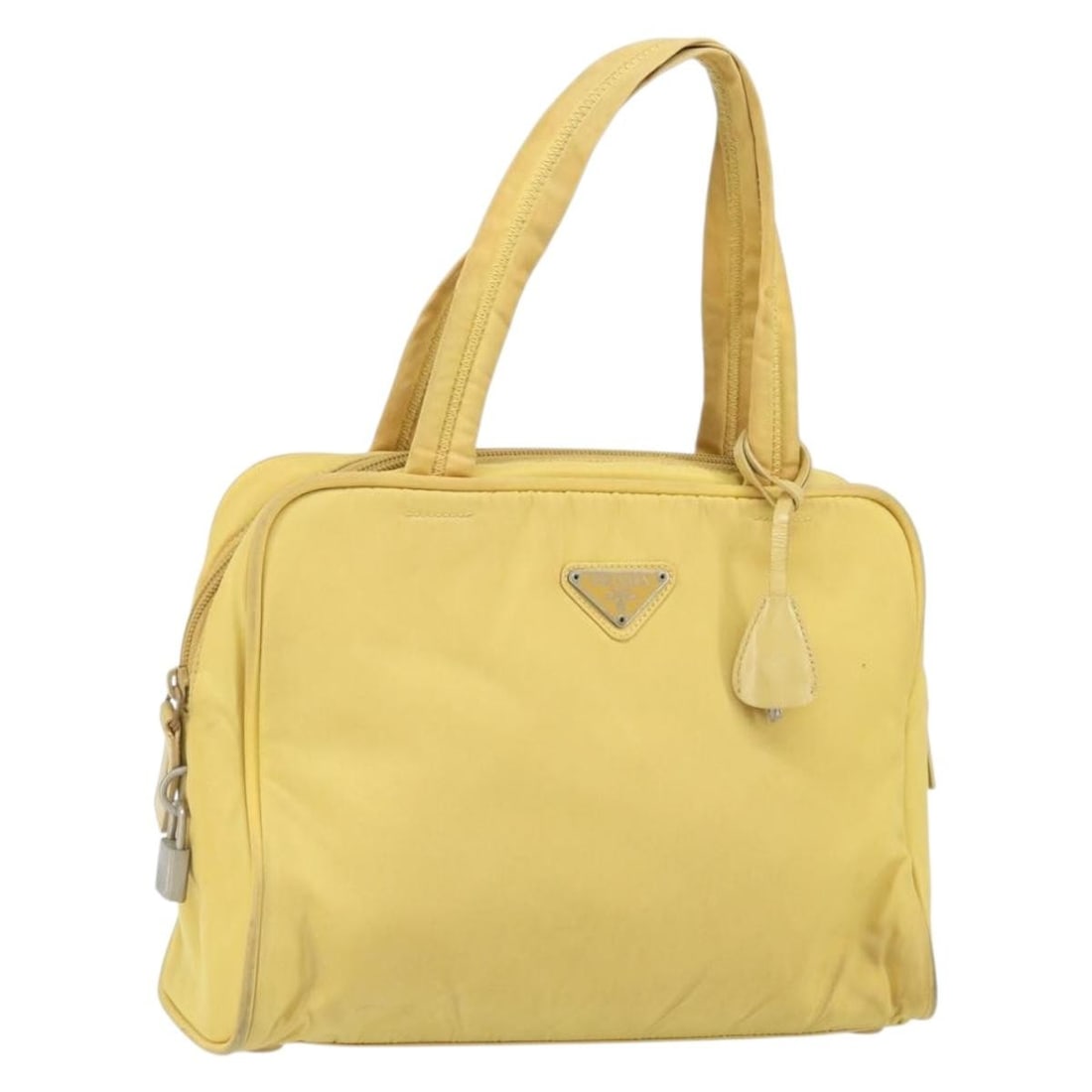 Yellow Nylon PRADA Handbag with Silver Accents and Accessories: Yellow Nylon PRADA Handbag with Silver Accents and Accessories This Prada hand bag is crafted from yellow and silver nylon and features a structured silhouette with dual top handles. The bag is made i