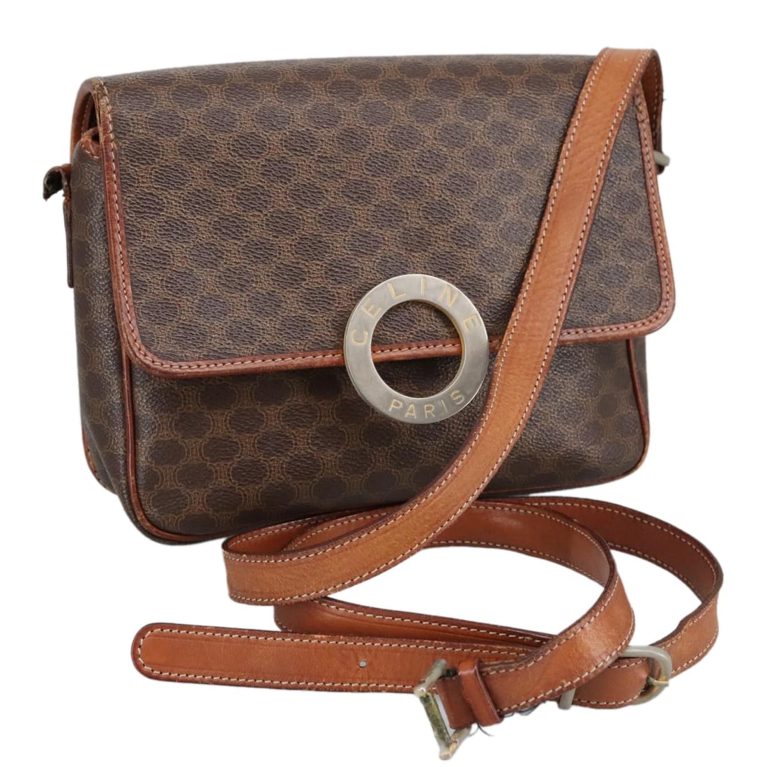 CELINE Brown PVC Leather Macadam Circle Shoulder Bag Made in Italy: CELINE Brown PVC Leather Macadam Circle Shoulder Bag Made in Italy The CELINE Macadam Canvas Circle Shoulder Bag is a stylish accessory, crafted from durable PVC leather in a rich brown color. This sh