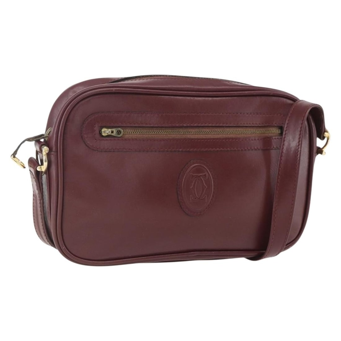 Burgundy Leather Shoulder Bag by Cartier Must de Cartier: Burgundy Leather Shoulder Bag by Cartier Must de Cartier This Must de Cartier shoulder bag is crafted from burgundy leather and designed for women. It features a shoulder strap and metal fittings. The