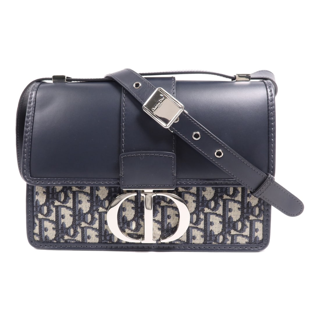 Christian Dior Montaigne 30 Navy Canvas Shoulder Bag: Christian Dior Montaigne 30 Navy Canvas Shoulder Bag Elevate your accessory collection with the Christian Dior Montaigne 30 Shoulder Bag. This exquisite piece features a sleek navy canvas exterior, sh