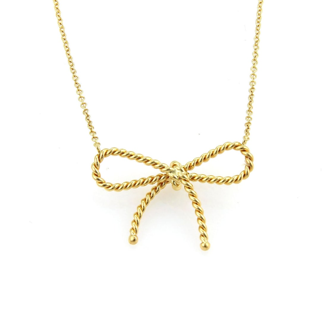 18k Yellow Gold Bow Pendant Necklace by Tiffany Twisted Cable Design: 18k Yellow Gold Bow Pendant Necklace by Tiffany Twisted Cable Design This vintage pendant necklace from Tiffany & Co. features a twisted cable wire design in 18k yellow gold, highlighted by a delicate