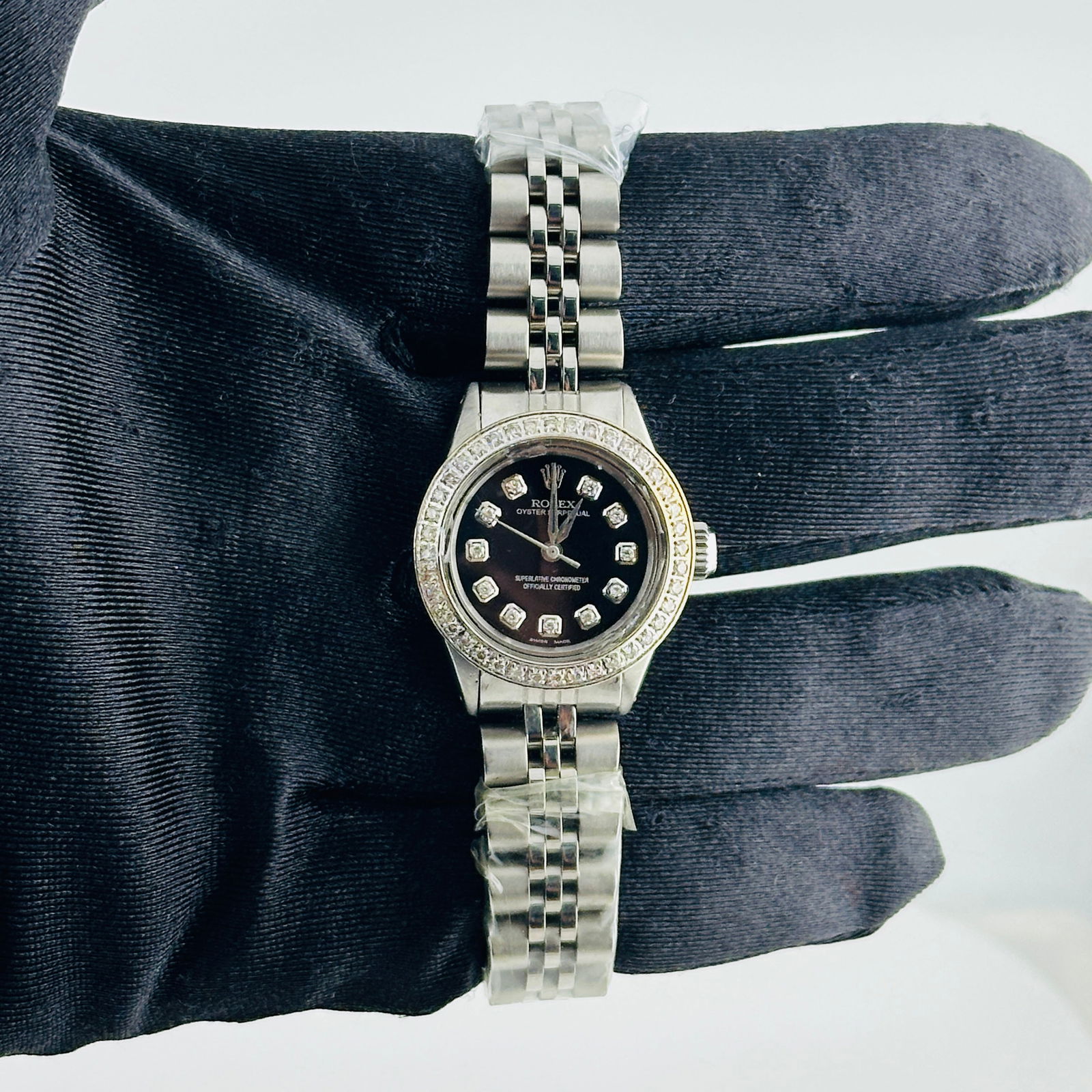 Ladies Rolex 6618 Oyster Perpetual Aftermarket Black Diamond Dial Jubilee Watch: Ladies Rolex 6618 Oyster Perpetual Aftermarket Black Diamond Dial Jubilee Watch This Rolex Oyster Perpetual features an aftermarket black diamond dial and an aftermarket pave diamond bezel, complement