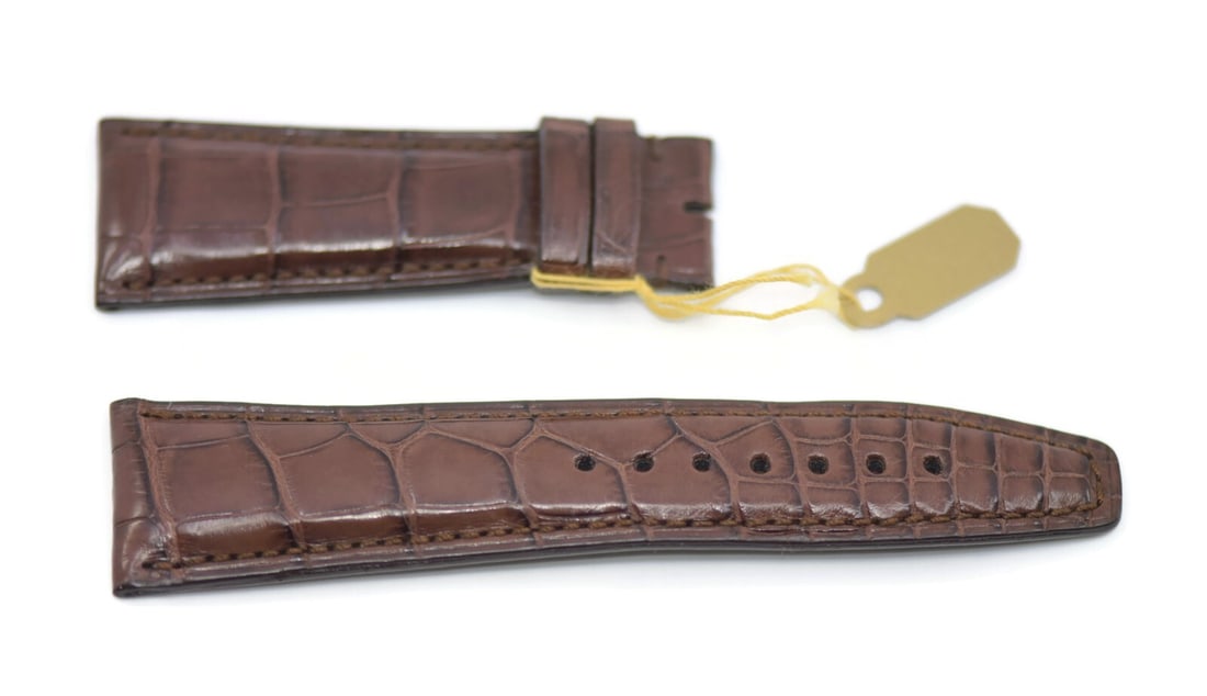 IWC Authentic Brown Leather Watch Strap 21.5mm Tapered: IWC Authentic Brown Leather Watch Strap 21.5mm Tapered Enhance your wristwatch with this authentic IWC Brown Leather Strap, designed for quality and style. Crafted from premium leather, this strap fea