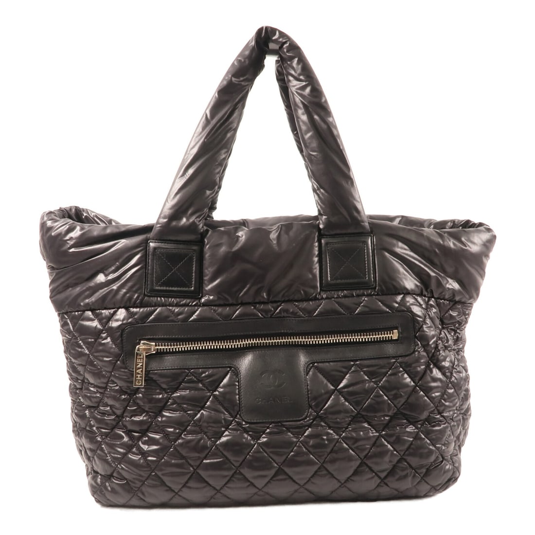 Coco Cocoon Black Nylon Tote by CHANEL with Silver Hardware: Coco Cocoon Black Nylon Tote by CHANEL with Silver Hardware This CHANEL Coco Cocoon tote bag features a sleek black nylon exterior and silver-tone hardware. Designed in a spacious tote style, it offer